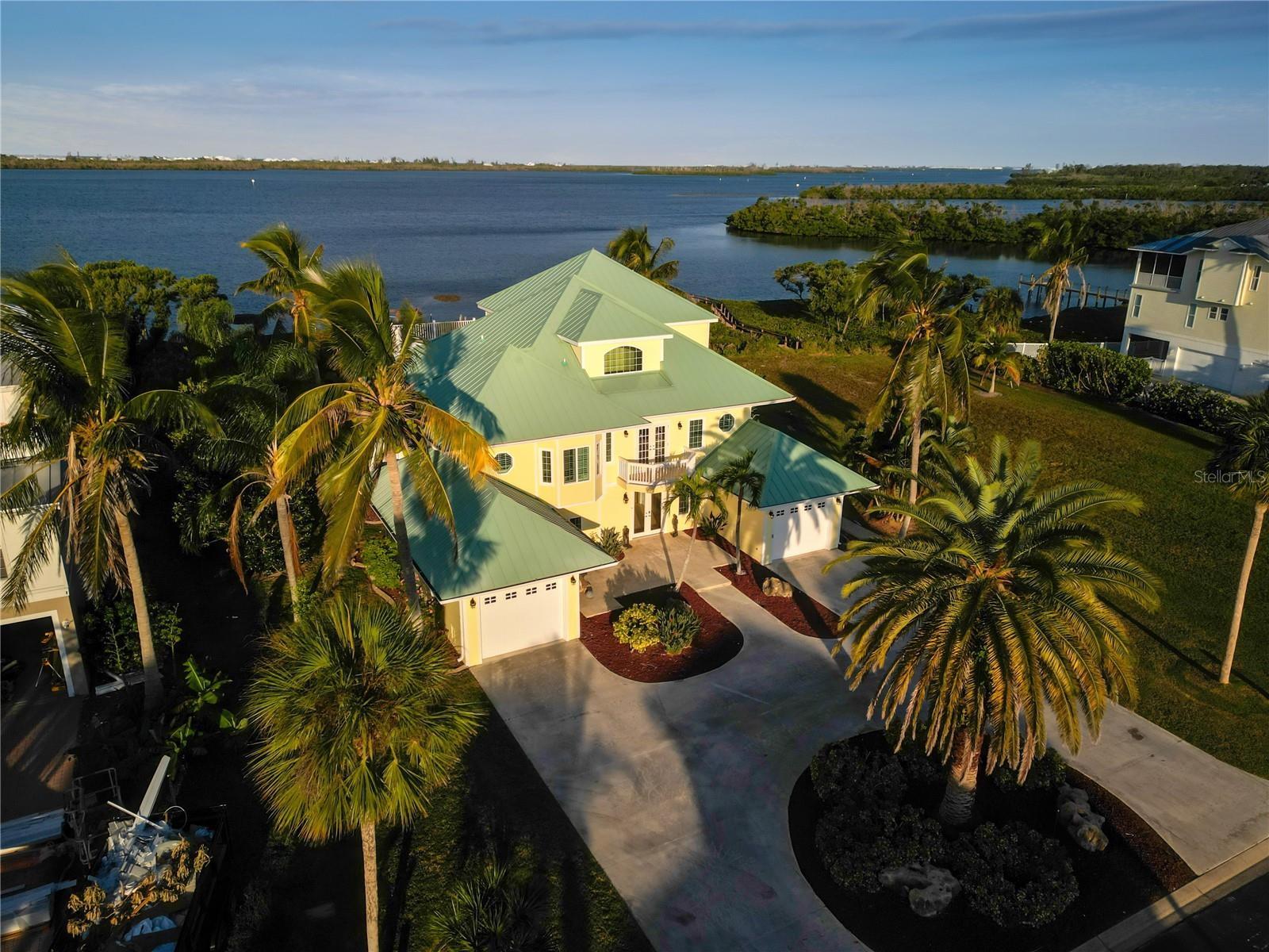 Stunning waterfront views on Lemon Bay-this home captures the gentle Gulf breezes and showcases breathtaking sunsets, ensuring that every moment here is one of relaxation and enjoyment. Located within the exclusive, gated community of Eagle Preserve Estates, this extraordinary bayfront home provides the best of Florida lifestyle. Offering water access and an enviable location, it boasts breathtaking, unobstructed vistas of Lemon Bay, surrounded by lush tropical landscaping and situated adjacent to the esteemed Lemon Bay Golf Club. This residence features an open concept main level living space where the great room flows seamlessly into a large well equipped kitchen and dining area, all offering endless bay views perfect for entertaining. This leads to an expansive covered lanai overlooking the pool, patio and bay. Intentional design features including built in wet bar, fireplace with soft tone coral and handcrafted backsplash created from reclaimed boat wood enhance the coastal ambiance. The primary bedroom is an oasis of space and tranquility, complete with dual walk-in closets, soaking tub and shower, wet bar and direct access to a private outdoor lanai where you can savor the sight of swaying palm trees and the soothing sounds of the bay. Your guests will delight in their private space, each with their own bath. 105' waterfrontage with dock for kayaks, jet skis, paddleboards and fishing. Recent upgrades add to the appeal of this already exceptional property including impact windows and doors, new standing seam metal roof, Hardie Board siding and Hardie Board vented soffits. Privately tucked away yet only a short distance to golf beaches, world-class fishing, waterfront, dining shopping, and the soft sand beaches of Boca Grande and Manasota Key. Truly an Extraordinary Home for Exceptional Living. Call today for your private showing.