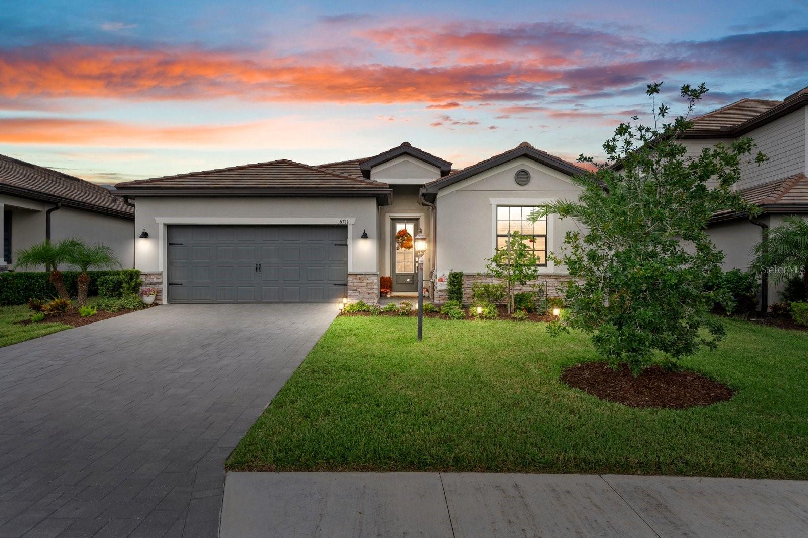 Indulge in the Florida lifestyle in this luxurious Trevi floorplan in Lorraine Lakes, where resort-style living meets everyday comfort! This thoughtfully designed home offers over 2,000 square feet of open living space with 4 bedrooms, 3 full bathrooms, and a 2-car garage featuring upgraded plank tile floors in the living areas. The split floor plan provides privacy and flexibility, while the spacious living/dining room and modern kitchen create the perfect setting for entertaining. Enjoy generous cabinetry, granite countertops, stainless steel appliances, and a large island that serves as the heart of the home.
The owner’s suite is a true retreat with dual walk-in closets and a spa-inspired bathroom featuring double vanities and an oversized walk-in shower. Three additional bedrooms offer versatility for guests, family, or a home office. Sliding glass doors open to a covered, screened-in lanai, perfect for relaxing outdoors and watching the beautiful sunrises over the lake. Enjoy added privacy and security with a fully fenced backyard, perfect for pets and entertaining.
Living in Lorraine Lakes means enjoying an unmatched lifestyle. The community features a clubhouse with a restaurant and bar, a putting green, resort-style pool with lap lanes and splash pad, fitness center, aerobics studio, indoor and outdoor basketball courts, tennis, pickleball, volleyball, and scenic walking paths and lakes. Families will enjoy the shaded playground, indoor arcade, and kids playroom. Experience the best of Lakewood Ranch with this prime location, offering effortless access to diverse shopping and dining, top-rated schools, championship golf courses, Lakewood Ranch Library, the Premier Sports Campus, and the stunning beaches of the Gulf Coast.