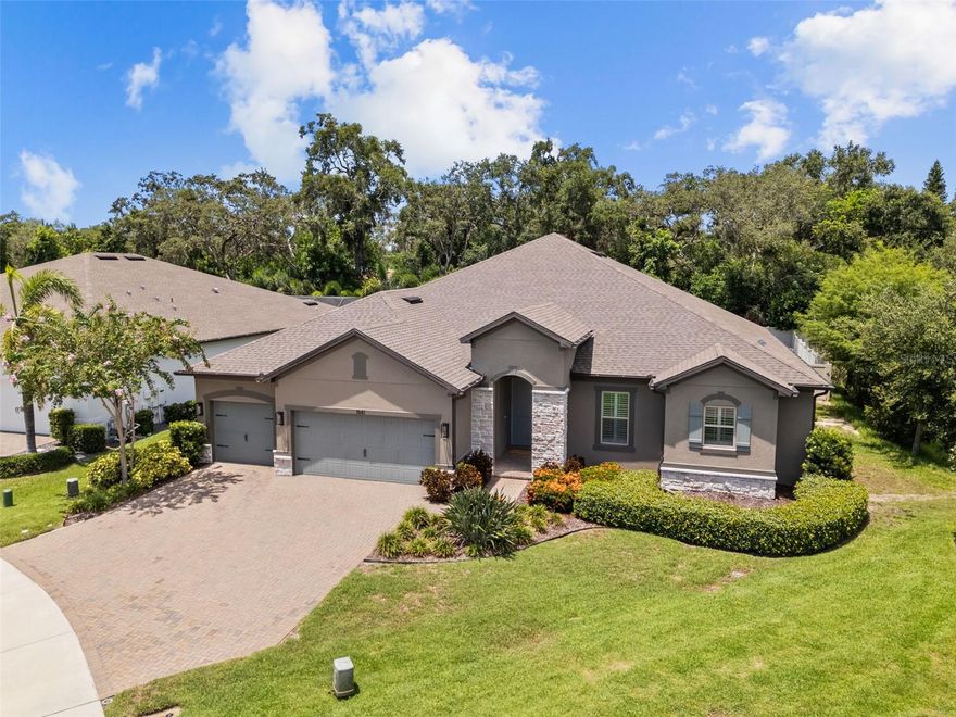 Luxury living awaits in the highly sought-after gated community of The Enclave at Palm Harbor. This exceptional 4-bedroom, 3-bathroom home with a spacious bonus room and 3-car garage was built in 2019 and offers 3,300 square feet of modern elegance and comfort. Enjoy the peace of mind that comes with a newer construction home, including up-to-date building codes, energy-efficient systems, hurricane-rated features, and minimal maintenance concerns for years to come. Designed for both everyday living and entertaining, the open-concept layout features abundant natural light, high ceilings, and stylish finishes throughout. The gourmet chef’s kitchen is equipped with stainless steel appliances, quartz countertops, custom cabinetry, a large center island, and a walk-in pantry, all flowing seamlessly into the expansive dining and living areas. The primary suite is a true retreat, offering a spa-inspired ensuite bath with dual vanities, oversized shower, and generous his and her walk-in closets. Three additional bedrooms and a versatile bonus room provide flexible space for guests, a home office, or play room. Step outside to your private backyard oasis with no rear neighbors and an adjacent unbuildable lot. The custom resort-style pool with sun shelf, pavered patio, crisp waterfall and gorgeous fire feature was designed with a covered lanai and outdoor entertainment area,  perfect for year-round relaxing. This unique residence also features ample storage, a spacious laundry room, and energy-efficient upgrades throughout. Located near top-rated schools including Palm Harbor University High, this home is just minutes from world-famous Gulf beaches such as Honeymoon Island and Clearwater Beach, charming downtown Palm Harbor, Innisbrook Golf Resort, and an easy commute to Dunedin, Tarpon Springs, and the Tampa International Airport. Experience refined Florida living with all the benefits of modern construction in one of Palm Harbor’s premier communities.  Schedule your showing of this model perfect home today!*See link to property tour*