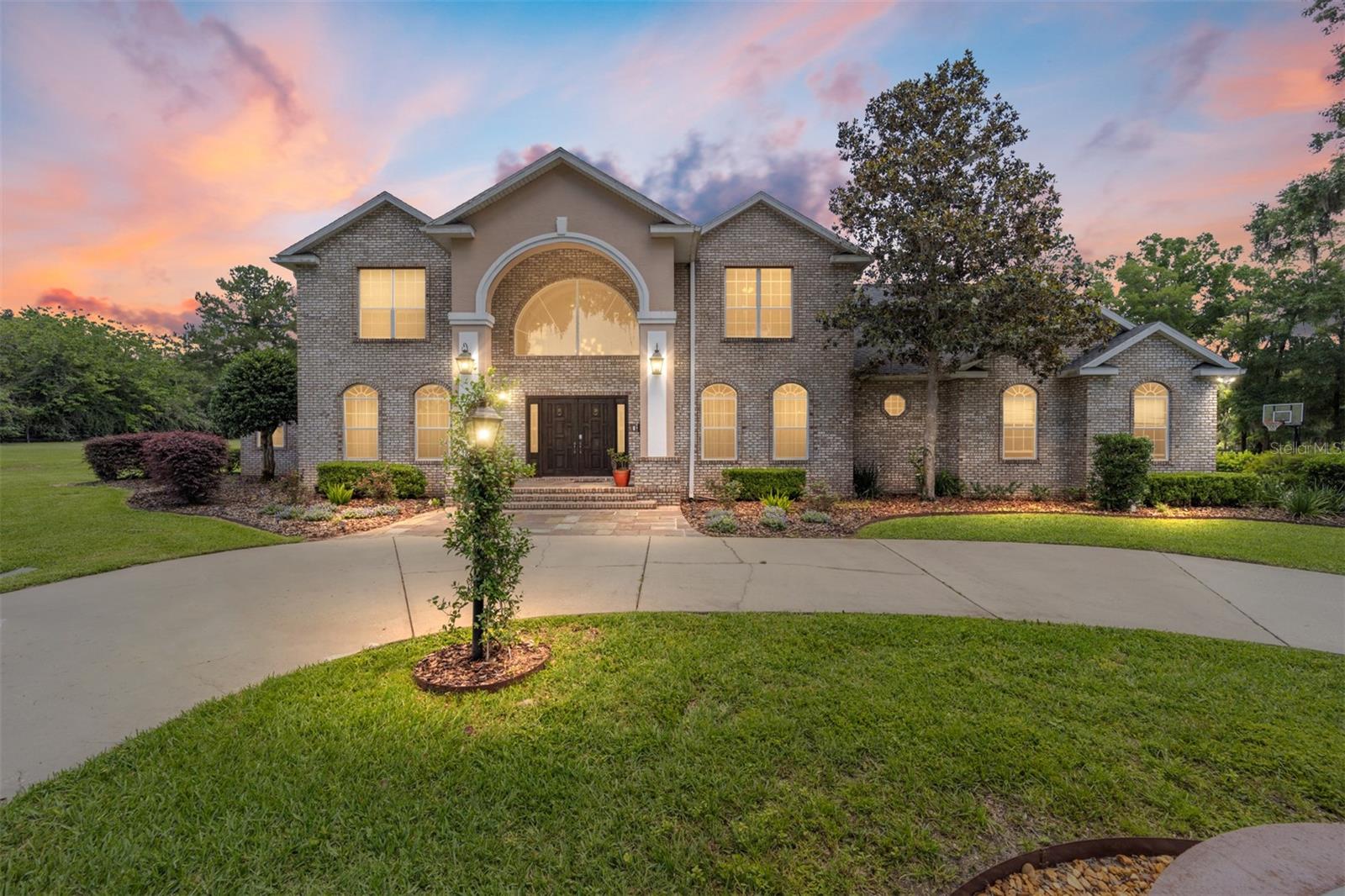 Welcome to an extraordinary estate home in the reputable gated community Turning Hawk II Ranch, set on a sprawling 5-acre lot. This luxurious property offers unparalleled privacy and tranquility, surrounded by lush landscapes and serene views. The main residence is a masterpiece of design and craftsmanship, featuring spacious living areas filled with natural light, high-end finishes, and elegant architectural details. The main house boasts five spacious bedrooms and four elegant bathrooms, one large bonus room and a library/office designed for ultimate comfort and convenience. The gourmet kitchen is a chef's dream, equipped with top-of-the-line appliances, custom cabinetry, and a large center island perfect for entertaining. The large sunken formal living and family living room are perfect for entertaining and is surrounded by French windows overlooking the scenic estate. The home is also equipped with a stair-lift (acron) that allows the convenience of movement for those who have difficulty walking up the stairs. The opulent master suite is a sanctuary of comfort, complete with a spa-like en-suite bathroom and generous His/Her walk-in closets. Imagine ending your day in the master bedroom, stepping out onto your private lanai to relax while watching the breathtaking sunset over your park like estate! Step outside to your private oasis, where a country club sized sparkling pool and separate hot tub invites you to relax and unwind. The expansive pool cabana is an entertainer's delight, featuring a fully equipped outdoor kitchen and wood burning pizza oven perfect for hosting summer barbecues and gatherings. The estate also includes a charming guest house, offering a comfortable and private retreat for visitors or extended family. The guest house features two bedrooms and two bathrooms, living area, full kitchen, pantry, laundry and attached garage ensuring your guests feel right at home. The Estate has been updated and upgraded with many features in recent time including a fruit orchard where you can harvest eight different kind of seasonal fruits year around and the expansive lawns have an upgraded automated sprinkler system. The neighborhood is equestrian friendly and the estate has enough space to build a stable and keep a few horses. This exceptional property in Turning Hawk II Ranch offers a unique blend of luxury, comfort, and functionality, making it the perfect place to call home. The property has direct access to the Florida Greenway for miles of trails. Don't miss this rare opportunity to own a Piece of Paradise.