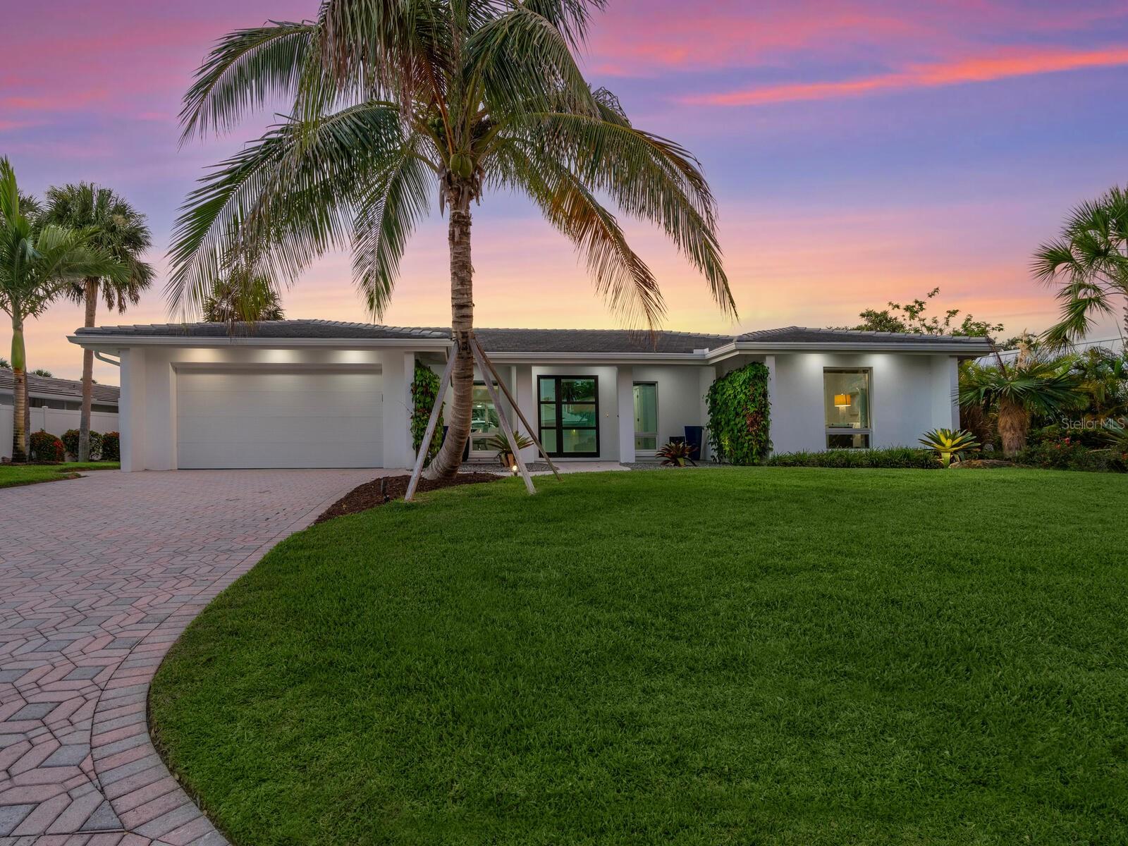 Welcome to Siesta Isles on Siesta Key where you will find this completely remodeled and fully furnished 3-bedroom/ 2 bath pool home on the Grand Canal basin. All the hard work has been finished and now is the time to enjoy. This stunning home is located 6/10ths of a mile walk to the world-famous Siesta Key Beach. As you enter the home you will immediately appreciate the amazing light filled open floor plan design. The kitchen has been arranged to allow for interacting with the family and guests while preparing great meals and refreshments on the large waterfall island. An oversized great room with a full wall of pocket sliders allows for bird, fish and Manatee watching or fabulous movie nights. The master Bedroom has pocket sliders that open directly out to the covered lanai. The views continue out the rear of the home to a beautiful saltwater pool and large deck also offering a covered lanai with motorized screens. Wander down to the dock which features a IMM 16,000 lb. boat lift with water and electric service. Enjoy your evenings dockside at the outdoor fire table while listening to the pool fountain surrounded by the lush lit landscaping.
The Grand Canal will take you out to the Intercoastal Waterway. You will enjoy the relaxed feel you get from this exceptional property.