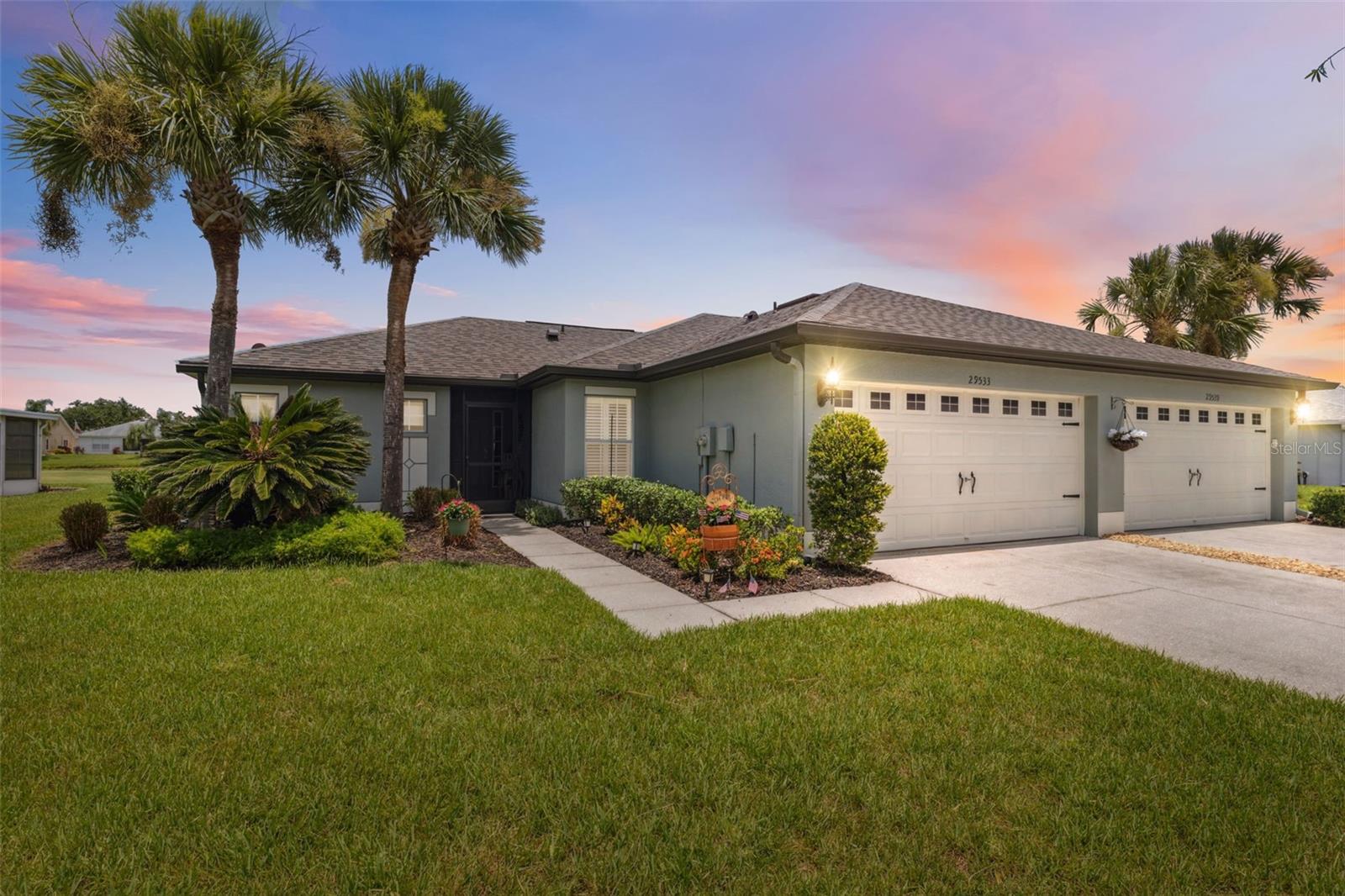 This beautifully updated 2-bedroom, 2-bathroom villa with a 2-car garage offers serene golf course living in the desirable 55+ community of Tampa Bay Golf and Country Club. The home has been meticulously maintained and upgraded with a brand-new shingle roof in November 2024, a freshly painted exterior with a 10-year warranty, and a full interior repaint in 2022. The screened, covered front porch welcomes you with charming landscaping, and the foyer opens to an airy, open-concept layout with cathedral ceilings in the main living area. The living room, dining area, and kitchen feature brand-new wood-look vinyl flooring, while both bathrooms have been upgraded with new tile floors and tile-surround showers. The kitchen is outfitted with new stainless steel appliances, granite countertops, repainted cabinetry, ceiling flood lights, a breakfast bar, and a spacious walk-in pantry. French doors in the dining area lead to a stunning 40x10 Florida room, built in 2022, with two skylights, two full walls of hurricane-rated sliding glass doors and windows, and peaceful views of the golf course and its pond. This expansive, heated and cooled space (not counted in taxable square footage) brings the usable area to approximately 1,650 sq ft, perfect for entertaining or relaxing year-round. Through the new sliding glass doors, you’ll find a nicely landscaped outdoor patio ideal for grilling or enjoying the sunshine. The split floor plan offers privacy with the primary suite on one side, which includes two walk-in closets, an ensuite bath with a step-in shower, linen closet, new vanity and mirror, and two private French doors that open to the Florida room. The second bedroom has a built-in closet and is near the guest bath with a tub/shower combo. Other features include a laundry room with corridor access to the garage, new ceiling light fixtures throughout, and custom bamboo shades in select rooms. The new A/C unit installed in 2023 includes a 10-year warranty and a full maintenance contract, and the garage door has been refurbished with new cables and an automatic open/close system. All windows and doors are hurricane rated for peace of mind. Enjoy resort-style living with access to the community’s golf course, clubhouse, two pools, tennis and pickleball courts, shuffleboard, spa/hot tub, fitness center, restaurant/bar, and 24-hour guarded gate. Ideally located just 4.5 miles from I-75, this home offers quick access to Tampa, Wesley Chapel, and surrounding areas—making commuting, traveling, and accessing nearby shopping, medical centers, and dining exceptionally convenient. Nearby attractions include the Tampa Premium Outlets (11 miles), offering a wide selection of shopping and dining options; The Grove at Wesley Chapel (13 miles), a lifestyle destination featuring movie theaters, restaurants, shops, and an outdoor entertainment venue; and AdventHealth Center Ice (15 miles), the largest ice sports complex in the Southeast, ideal for skating, hockey, and events. You’re also just minutes from everyday conveniences like grocery stores, pharmacies, and golf cart-friendly restaurants and shops.