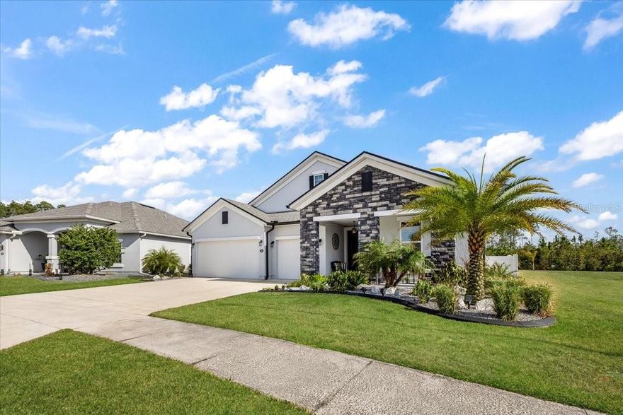 A rare opportunity to own the premier home in Palm Coast’s gated Grand Landings community. This 2022-built, 5-bedroom, 4-bath residence offers nearly 3,000 square feet of beautifully designed living space on an oversized lakefront lot with extra space between neighboring homes for exceptional privacy. From the moment you arrive, you’ll appreciate unobstructed lake views from both the front and back of the home, with no future building possible in front to block your scenery.

The heart of this property is the resort-style outdoor oasis. A huge premium heated saltwater pool with spa anchors the expansive screened lanai. Built-in custom LED lighting around the entire lanai create the perfect setting for relaxing mornings, sunset dinners, and unforgettable gatherings. The beautifully landscaped yard, custom curbing, and wide-water views combine to make this one of the most impressive outdoor living spaces in Grand Landings.

Inside, an expansive gourmet kitchen steals the show with a HUGE center island, beautiful quartz countertops, upgraded cabinetry, and a custom bar area, all served by a whole-home UDI water filtration system. Elegant coffered ceilings in the main living area and a tray ceiling in the primary suite add a high-end, custom feel, while the extended primary bedroom lives like a private retreat. A large upstairs bedroom with its own private bath is ideal for guests, multigenerational living, or a quiet home office suite.

Thoughtful features continue with a 3-car garage offering overhead storage racks and plywood attic flooring with pull-down ladder, a custom laundry room, and a central vacuum system with garage access that keeps everything neat and easy to maintain. Grand Landings residents enjoy a community pool, clubhouse,  dog park, playground, and scenic walking trails with low HOA fees and no CDD. If you’re searching for a meticulously maintained, truly move-in-ready home that outshines new construction in style, condition, and outdoor living, this is the one you need to see