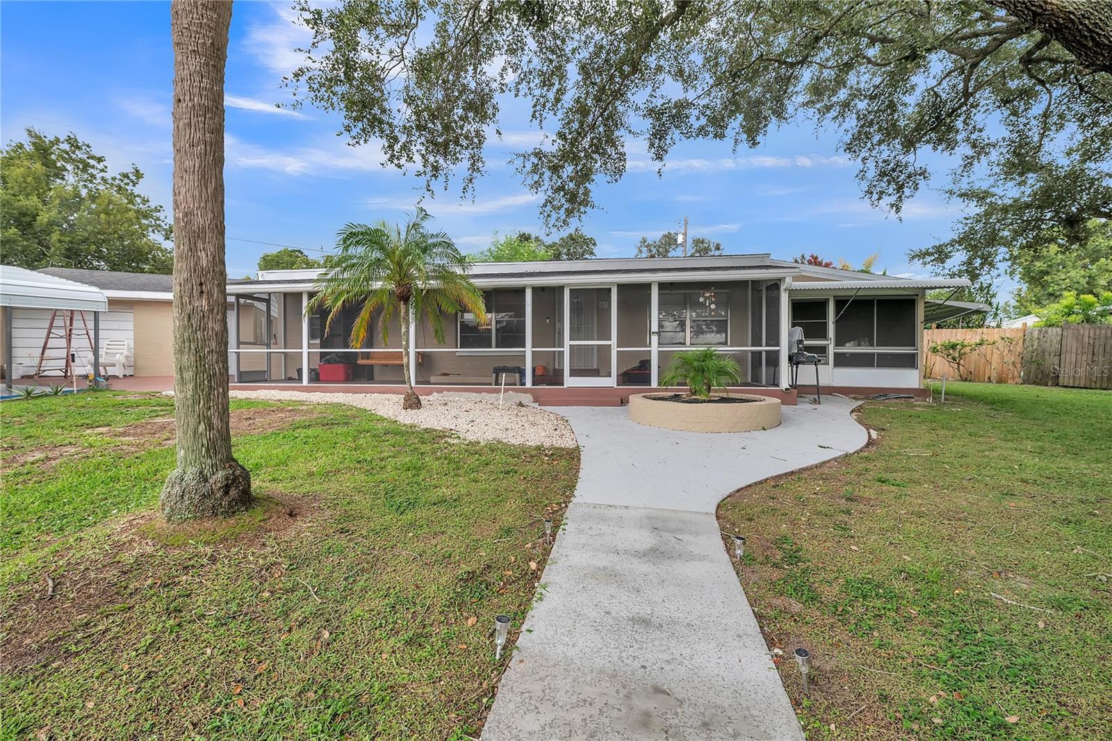 Well-maintained 3-bedroom, 2-bath concrete block home on a 0.25-acre lot with recent updates. Roof replaced around 2018-2019 (prior owner). New water heater (2024), well pump (2025), and updated irrigation system (2025). Includes remodeled detached studio (2024), 16x10 shed, screened lanai, generator plug-in, and RV outlet. Bathroom leak from old water heater has been remediated. Some flooring and outlets may need updates. No HOA. Quiet neighborhood with well and septic. Block construction with dry attic.