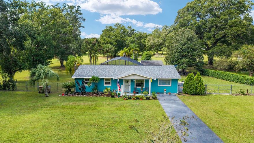 Animal lover's tranquil paradise on 1.62 acres in the scenic and historic area of Lady Lake! Claim home sweet home to this charming, immaculate four-bedroom, two-bath mini-farm loaded with upgrades offering three bonus rooms! Inviting and comfortable living room, plentiful counter space in the kitchen, both baths remodeled with walk-in showers with glass wall, glass sliders open to the sunshine room leading you to the lovely relaxing lanai with an in-ground solar-heated pool overlooking your lovely, fenced oasis of cleared land with mature trees. The large laundry/mud room offers a closet and plentiful space for a desk/craft/multi-purpose area. A detached one-car garage can serve a variety of uses. Bring your farm animals, children and gardening tools. There is a chicken coop for chickens and roosters. Enjoy a little country quiet while having the luxury of being a few minutes to shopping, dining and The Villages for entertainment. Updates include new patio pavers around pool, outside recently painted, re-screened lanai in 2021, pool resurfaced, driveway and front patio painted, new roof in August 2024 (five-year workmanship warranty and 15-year shingles warranty), water heater in 2021, pool solar panels in June 2021 (10-year warranty), pool pump in June 2021 (under  warranty), air conditioner September 2024 (under warranty until 2034), new guest shower remodeled in 2022, well pump in 2018, septic inspected in 2023 and new breaker panel in 2021. Super cute place!