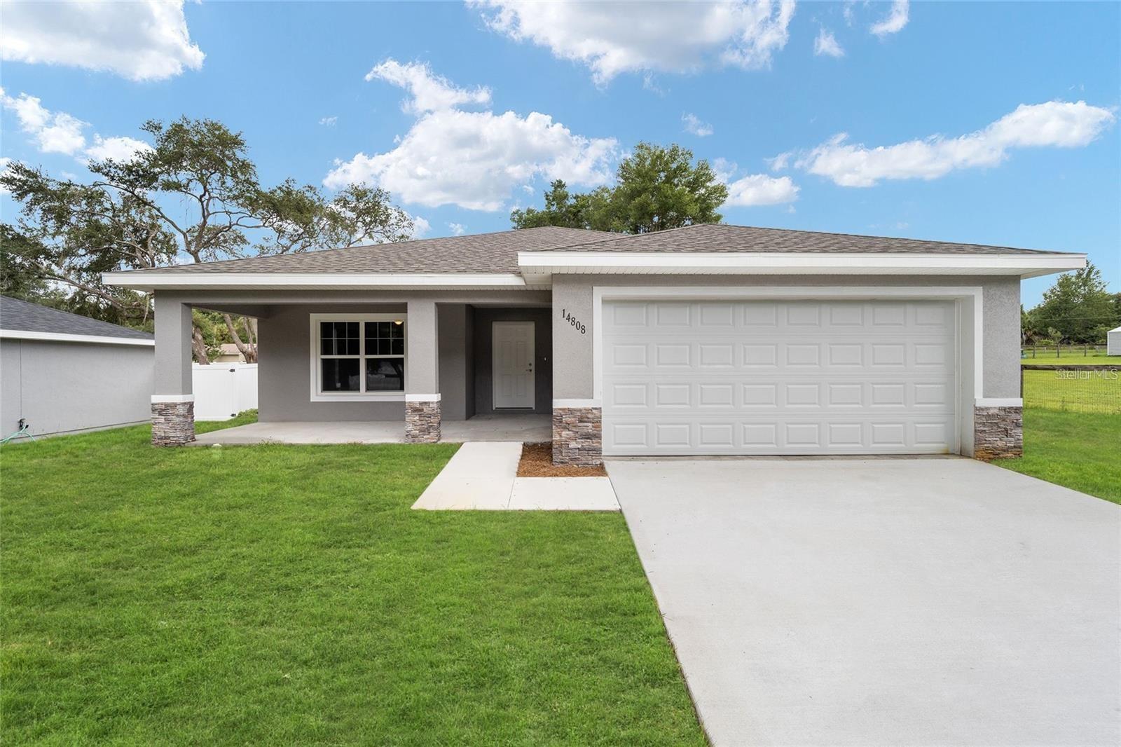 One or more photo(s) has been virtually staged. New Construction home in Lake Weir Shores!! Beautiful scenic country setting just minutes from Lake Weir, Ocala and the Villages. Community boat ramp available access to Lake Weir. You will LOVE the layout of this almost 1800 sq ft of living space. GRANITE countertops throughout, HUGE pantry, HUGE master closet, awesome master bathroom design AND this home comes with both a large front porch and back porch. Privacy fence was just installed. Carney Island Park is a short drive away, offering walking & biking trails, playground and public beach access to famous Lake Weir for swimming along with two waterfront dining options on Lake Weir. Come Check out this home, you won't to miss it!