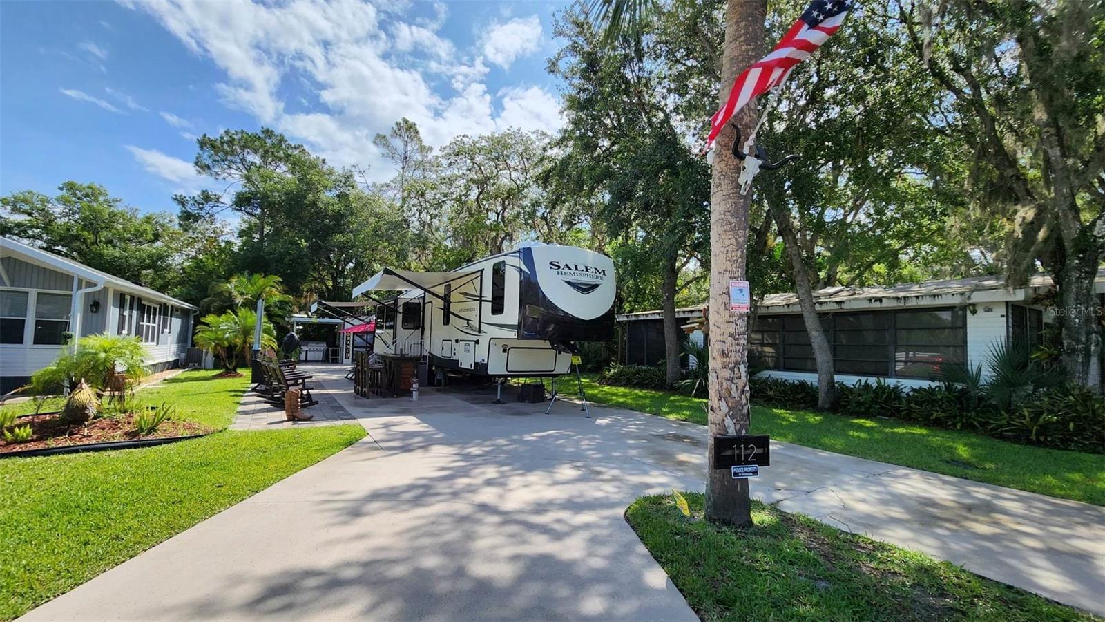 Escape to the tranquility of River Ranch Florida and indulge in the ultimate RV Resort Experience! This is truly the perfect vacation home or you can call it HOME SWEET HOME and enjoy full time resort living in the popular PHASE ONE of River Ranch RV Resort!
This property is conveniently located walking distance to the pool, laundry, and bathhouse.
This Lot is 45x103 and offers green space on both sides and in the back and offers an extended patio seating area with pavers! There is a relaxing hammock hung between 2 canopy oaks where you can enjoy a mid afternoon nap under the shade. All of the furnishings on the lot are custom made to include a bar with stools, several rocking chairs and a large dining table with seating for 10! There is also a very unique and beautiful fireplace which serves as a focal point for campfire gatherings. The outdoor furnishings are quality custom-made pieces and add to the nostalgia of the Ranch! All furnishings come with covers.
The Shed is equipped with a private BATHROOM, full size refrigerator, storage/tool chest with counter top, a water cooler, a stainless steel sink, a stackable washer and dryer and a water heater. The Lot offers an expansive outdoor living space that features an extended paved area and several seating and entertaining areas. The property is equipped with security cameras and 2 storage sheds behind the property.
Enjoy access to numerous activities such as Pools, Tennis, Pickle Ball, Clubhouse, Social Events, Fitness Center, Billiards, Poker Room, and more! Westgate River Ranch Resort is the ultimate getaway that promises fun day time activities, night life, gorgeous sunsets and peaceful evening golf cart rides.