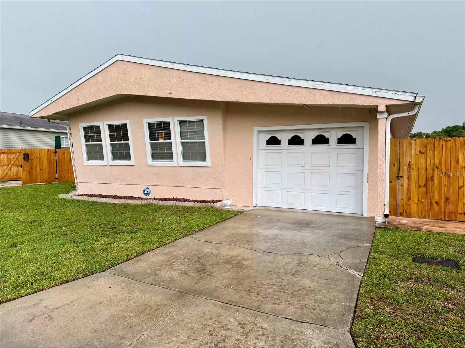 Discover Florida living at its best with this fully furnished 2-bedroom, 2-bath mobile home perfectly positioned on a private waterfront lot, and best of all, NO HOA and NO LOT RENT! Just bring your toothbrush! Enjoy peace of mind with a 2018 roof, 1 car garage, a fantastic large workshop with tools included, no known history of flooding, and a new 6-ft privacy fence. Whether you're looking for a primary residence, seasonal retreat, or a short-term rental investment, this property offers incredible potential. The former back decking was removed, providing a clean slate for the next owner to design their ideal outdoor space overlooking the water. Please note: Due to the age of the home (1973), this property is being offered as a cash-only purchase. That said, you'll be pleasantly surprised—it does not look or feel its age.