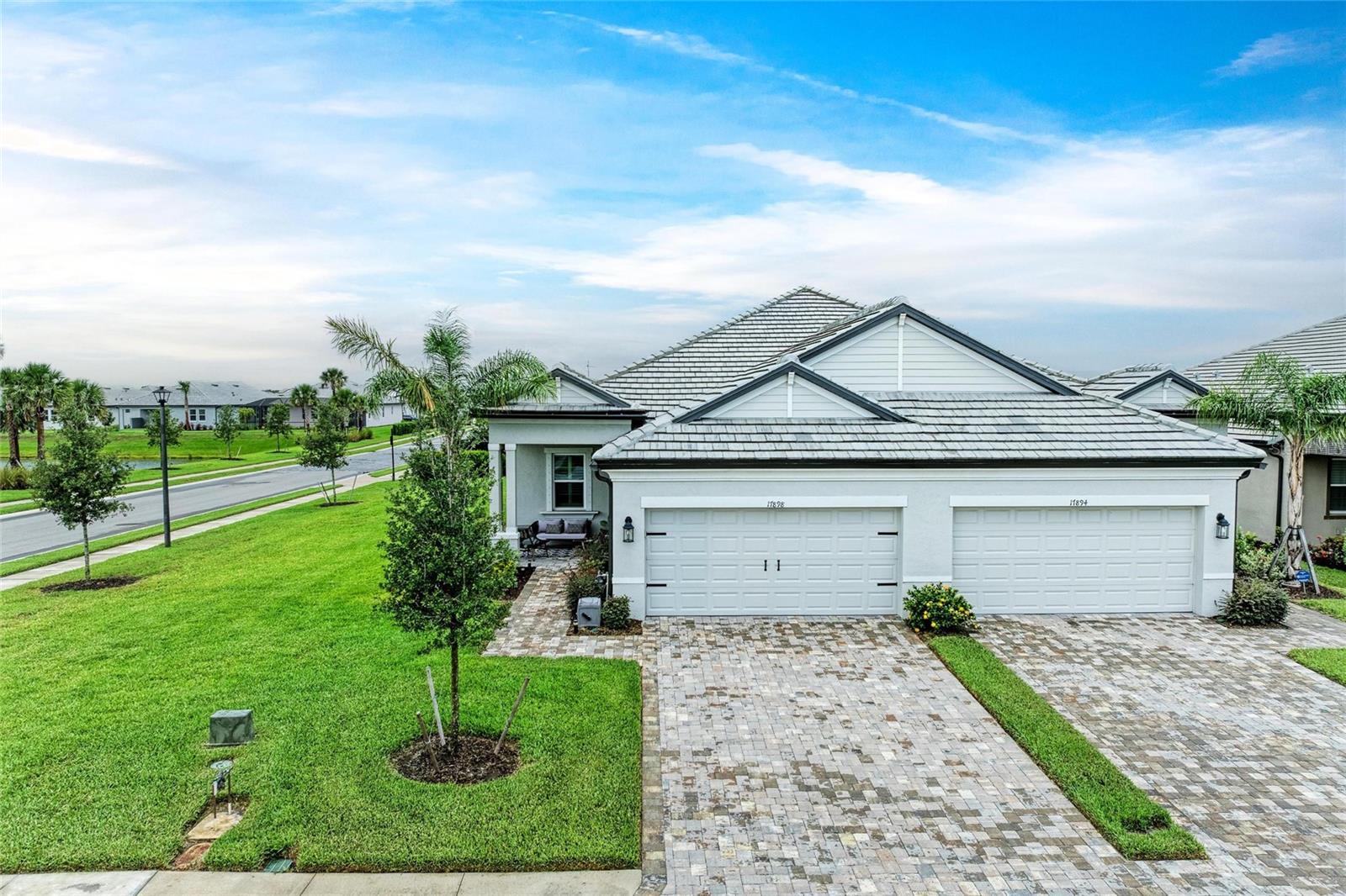 REDUCED! Amazing rental opportunity in resort style living! Welcome to one of Lakewood Ranch’s most sought-after gated communities—Sweetwater. Nestled on a premium corner lot with tranquil lake views, this impeccably upgraded villa offers the perfect balance of elegance, space, and modern style. Throughout the main living areas and owner's suite, you'll find upgraded luxury vinyl plank (LVP) flooring that adds elegance and durability. The kitchen is a true chef’s haven, featuring quartz countertops, a custom backsplash, soft-close cabinetry, and a 5-burner gas range with double oven and built-in air fryer. Smart home features abound, including Alexa-enabled motorized blinds in the living room and owner's suite, under-cabinet kitchen lighting, and a smart entry door lock. Designer touches such as plantation shutters, updated light fixtures, and ceiling fans in every room elevate the home's style and comfort. Wake up to tranquil lake views from the generous owner’s suite and unwind in the screened-in lanai—perfect for relaxing or entertaining against a peaceful waterfront backdrop. Located just minutes from UTC shopping, Waterside, Gulf Coast beaches, and vibrant downtown Sarasota, this turnkey home truly offers the best of luxury, lifestyle, and convenience. Available unfurnished for 12 months lease period with 1 small pet with approval. Open to shorter terms from 6 months or more.