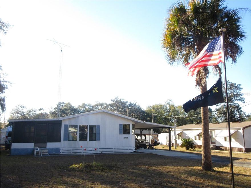MINT CONDITION LAKE ACCESS 2/2 1989 24X38 SKYLINE DOUBLEWIDE MOBILE HOME LOCATED IN THE FAMOUS OCALA NATIONAL FOREST! Outside features a new 2025 twenty six guage "ultra Rib" metal roof over with synthetic underlayment resistant to 130 MPH winds. Also included outside is a 12x28 carport with attached 8x10 laundry room. There are also laundry facilities inside the home. Also featured is a breezy 12x17 Florida room with vinyl windows on a concrete block foundation for your year round use. Or add permanent windows and a closet and the Florida becomes an instant 3rd Bedroom! Also included is a handy 8x12 workshop/golf cart storage building plus a second 10x10 shed. The Central A/C Heat pump is a recent 2023 model. The back yard has a new chain link fence for your pets. The home itself is in very good condition and comes partially furnished and includes the range, refrigerator, (3 year old washer), dryer, microwave, all window dressings and a handy eat-in snack bar separate from the dining area. All sits on a spacious 80x150 .28 acre paved road lot with fantastic community access to 400 acre "North Lake" with some of the BEST BIG BASS FISHING, JET SKIING, KAYAKING, SKIING AND BOATING ANYWHERE IN THE STATE OF FLORIDA! The community has a large double boatramp, marina, clubhouse and a lovely swimming beach picnic area on the lake. This is an absolute great buy at just $164,000! Hurry! Home is located in the Ocala National Forest which affords you almost a ½ million acres of Forest to roam, 600 lakes, 2 rivers, Juniper Springs, Silver Glen Springs, Salt Springs, Swimming, Skiing, Big BASS Fishing, Boating, Camping, Hiking, Horse back riding and some of the best ATV riding anywhere. Daytona Beach is just 1 hour away. Let the fun begin! You need it!