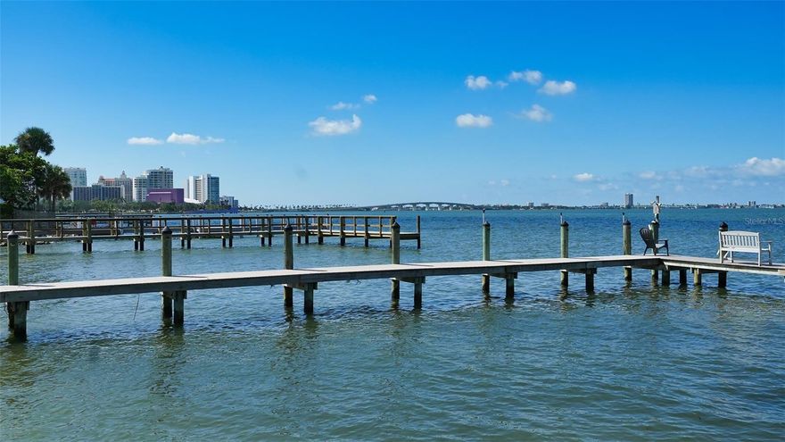 Situated on nearly an acre of prime waterfront land, this property offers sweeping breathtaking vistas of Sarasota Bay and the City skyline. 
Just minutes away from downtown Sarasota, the approach to this estate is graced by a lush canopy of trees and tropical foliage. While the current residence is suitable for immediate occupancy, it also presents an incredible opportunity for those contemplating the construction of a new home. The layout of the existing home includes a living room, family room/library, kitchen, and formal dining room on the main level. A screened lanai overlooks the saltwater pool. Upstairs, you'll find three bedrooms and 3 ½ baths, complemented by a generously sized enclosed lanai located just off the oversized Primary suite, that provides unparalleled views. Other notable features include a grand two story entryway, ample storage space, floor-to-ceiling built-in bookshelves, an abundance of windows and sliding doors that flood the interior with natural light. For those with nautical aspirations, we are pleased to inform you that the owner consulted with a dock company and has been advised that a dock can be added to this property. The process requires the new homeowner to obtain all necessary permits for construction and enlist a licensed contractor to oversee the project. Welcome to a hidden slice of paradise, only a stone’s throw to all of the hot spots in downtown Sarasota.