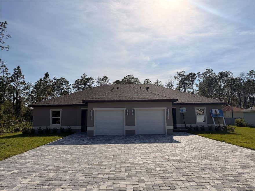 Beautiful new construction duplex unit offering approximately 1,200 sq ft of comfortable living space in the fast-growing Seminole Woods subdivision. This well-designed home features 3 bedrooms, 2 full bathrooms, a covered back patio, and a 1-car garage with an automatic opener. The two units are separated by a professionally insulated partition wall, enhancing privacy and reducing sound transfer. Inside, you’ll find an open living and kitchen layout ideal for everyday living and entertaining. The kitchen showcases granite countertops, 42-inch cabinetry, stainless steel appliances, and plenty of storage space. The spacious main living area is highlighted by tray ceilings, modern lighting, and durable tile flooring throughout. Both bathrooms are finished with raised vanities and cultured marble tops. Each bedroom includes a ceiling fan for year-round comfort. The oversized paved driveway allows parking for up to four vehicles per unit. Now available for lease. Conveniently situated near schools, shopping, Town Center, AdventHealth, and just minutes from Flagler Beach and Daytona Beach