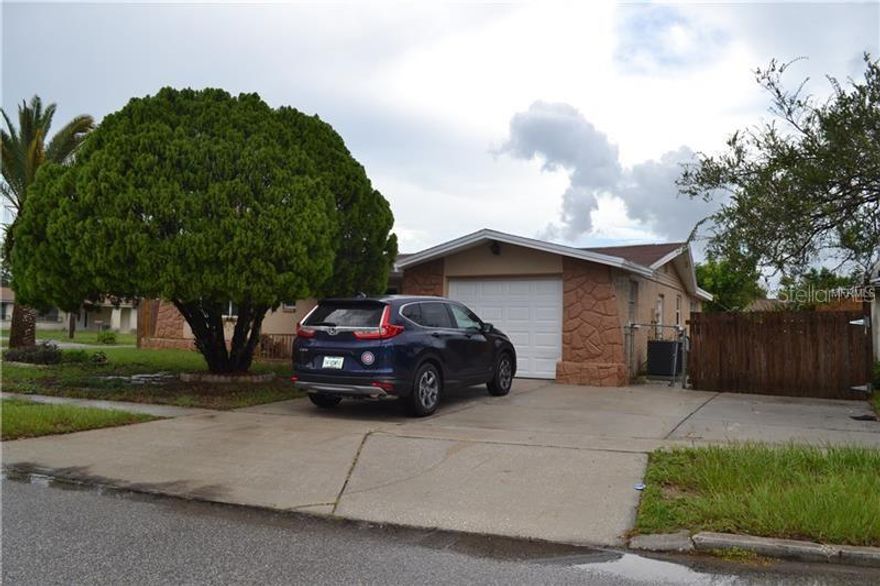 Renovated Corner lot 3 bed/2 bath home in New Port Richey! No expense was spared in the upgrading of this home including the beautiful designer paint throughout which is a perfect match for any decor. Gorgeous dark wood flooring flows through the entire home. The bright and open living space is great for entertaining with a combined living and dining room which is also open to the upgraded kitchen. The kitchen has brand new granite counters, tile backsplash, ample wood cabinetry, and brand new stainless-steel appliances. The breakfast bar is perfect for keeping the conversations going. There is an additional living space which is ideal for an extra sitting room or playroom. The master bedroom is spacious, large enough for king size furniture and features a walk-in closet and upgraded private bathroom. The additional 2 bedrooms are light and bright, with plenty of closet space and natural sunlight. Enjoy the privacy of your large fenced in back yard, a great space for playing in the Florida sunshine or having get-together or BBQs. Minutes from US 19 and SR 54, close to beautiful Florida beaches and parks, local shopping and restaurants. In addition to the advertised base rent, all residents are enrolled in the Resident Benefits Package (RBP) for $50.00/month which includes HVAC air filter delivery, credit building to help boost your credit score with timely rent payments, utility concierge service making utility connection a breeze during your move-in, and much more! More details upon application. Pets welcome, no aggressive breeds. Vacant and available now!