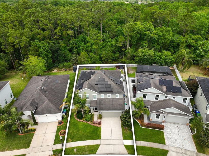 WATCH VIDEO TOUR! Welcome to this SPACIOUS 5 BEDROOM house over 3,000 SQ FT with a PRIVATE TREE VIEW and EXPANSIVE BACKYARD already set up for GARDENING and entertaining. The heart of the home is the HUGE KITCHEN with ADDITIONAL CABINETRY, EXTENDED COUNTER SPACE, and UPDATED PENDANT LIGHTING over the island. Enjoy peaceful views from the kitchen overlooking a LARGE BACKYARD with GAZEBO and FRUIT TREES including MANGO, DRAGON FRUIT, LYCHEE, and BLUEBERRY. Custom WINDOW PLANTATION SHUTTERS throughout the entire house. Downstairs GUEST BEDROOM with closet (or use as OFFICE) and HALF BATH. The large LOFT UPSTAIRS has BUILT-IN SURROUND SOUND SPEAKERS. LARGE BEDROOMS upstairs. The PRIMARY SUITE features DOUBLE DOORS, TWO WALK-IN CLOSETS, and an ENSUITE BATH. Energy-efficient upgrades include SOLAR PANELS (Seller will pay in full at Closing), WHOLE-HOUSE WATER SOFTENER system, and UNDER-SINK WATER FILTER in the kitchen. All major systems—ROOF, HVAC, and WATER HEATER are WELL MAINTAINED. COMMUNITY AMENITIES include NATURE WALKING TRAIL, COMMUNITY PLAYGROUND, and BENCHES BY LAKE, PET FRIENDLY neighborhood. Located just 10 minutes to Waterford Lakes Town Center and 20 minutes to Orlando International Airport. This home is a rare combination of SPACE, UPGRADES, and LOCATION—schedule your showing today! TO SEE MORE WATCH THE VIDEO/VIRTUAL TOUR!