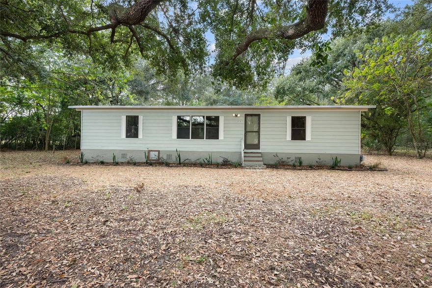 This freshly renovated 3/2 mobile home sits on a serene .69 acre lot with plenty of trees for shade and privacy. Inside, the open layout highlights new flooring, handmade cabinet doors, tile countertops, and lots of built-ins that make the space both functional and inviting. Step out onto the new deck and enjoy the peaceful surroundings-ideal for morning coffee or evening unwinding.  A charming home with thoughtful updates in a wonderfully quiet area. This home is a must see!!!