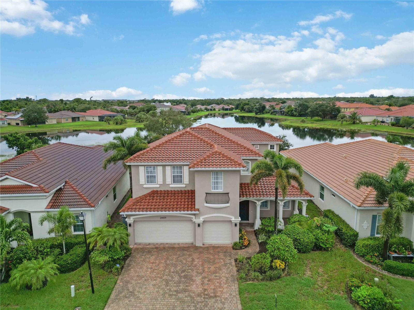 This exceptionally remodeled 5-bedroom, 4.5-bath home offers over 4,000 sq. ft. of refined living space in the coveted River Club community of Punta Gorda. Designed with elegance and function in mind, the home blends soaring ceilings, high-end finishes, and a unique floor plan that captures serene lake views and spectacular western sunsets.
The first floor showcases a private guest suite with dedicated bath, a formal dining room, an inviting family room, and a spacious office. The heart of the home is the chef’s kitchen, unparalleled in both size and design, featuring a waterfall quartz island, over 46 feet of quartz counter space, abundant cabinetry, wine storage, a butler’s pantry, and beverage center—all overlooking the living room and lanai.
Upstairs, a loft-style sitting area leads to the penthouse-like primary suite, complete with a private sitting area, custom built-ins, quartz counters, a wine refrigerator, and two expansive walk-in closets. The spa-inspired primary bath boasts a large soaking tub, walk-in shower, and model-quality finishes. Three additional upstairs bedrooms each include a dedicated bath, ensuring comfort and privacy for family and guests.
Additional highlights include a 3-car garage with new epoxy floors, paver driveway, hurricane shutters, and two brand new 22 SEER A/C units with whole-home air purification. Outside, the screened-in lanai provides the perfect setting to relax and enjoy the lakefront sunsets.
Residents of River Club enjoy a resort-style pool, clubhouse, and community park within a quiet, gated setting. Conveniently located near downtown Punta Gorda, Fishermen’s Village, Charlotte Harbor, and I-75, this property also benefits from its X Flood Zone designation for added peace of mind. This property is more than a home—it’s a lifestyle. Schedule your showing today!