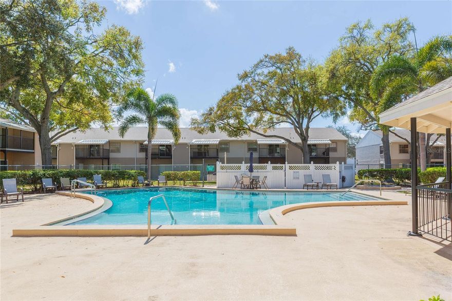 First-Time Home Buyers & Conventional Financing Welcome!  Welcome to Fair Oaks, ideally located in the heart of Tampa Bay with unbeatable access to St. Petersburg, MacDill Air Force Base, and Downtown Tampa — all within approximately 10 minutes. Positioned near the Gandy corridor and Selmon Expressway, this location offers exceptional convenience for young professionals, military personnel, and investors alike.  Inside, this condominium features luxury travertine flooring throughout, creating a cohesive and elevated feel from the moment you enter. The open-concept living and dining area provides an inviting space to comfortably entertain friends and family while maintaining a practical everyday layout.  The kitchen was upgraded within the last decade and showcases wood cabinetry, granite countertops, and updated appliances — blending durability with timeless design.  The guest bathroom has been fully remodeled with a new vanity, tiled bathtub, and updated fixtures for a fresh, modern touch.  Tucked toward the rear of the unit, the spacious primary bedroom easily accommodates a king-sized bed and any other additional furnishings you may have: it is also equipped with a built-in closet for your clothing necessities.  Step outside to your private screened-in balcony — a peaceful retreat with no rear neighbors, perfect for enjoying a quiet morning coffee or unwinding after a long day.  For added convenience, the condo includes its own laundry closet, making weekend chores simple and accessible. Even better, your reserved parking space is just steps from the front door.  Residents enjoy access to community amenities including a clubhouse and pool — ideal for relaxing afternoons or a refreshing weekend swim.  If you're looking for a centrally located condo that offers easy access to work, dining, nightlife, schools, and major commuting routes throughout Tampa Bay, this opportunity checks every box.  Schedule your private showing today and experience the convenience for yourself.