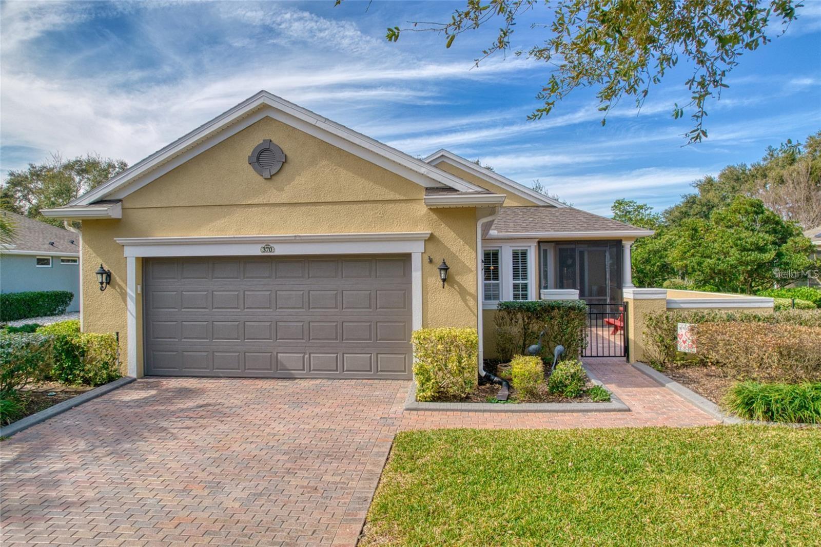 Motivated Sellers! SO MUCH TO LOVE in this 2 bedroom, 2 bath plus bonus room expanded Gardenia home. This open concept expanded Gardenia (Shea Built) home is sure to impress. Over 200 sq feet bigger than the original floor plan resulting in an oversized garage and larger kitchen, bedroom, bathroom, courtyard and laundry room. Seller is motivated! SOLAR PANELS pay for your electric all summer long! Backs up to water with no rear neighbors! Enter the home through the concrete fenced courtyard with brick pavers. Beautiful new hardwood floors in living area and bedrooms upgraded tile in wet areas. No carpet!! Wood shutters and crown molding throughout. Storage galore in the large kitchen with quartz countertops, wood cabinets, under cabinet lighting, walk in pantry, and top of the line appliances. Laundry room has full wall of cabinets and sink w new washer/dryer. Enjoy your morning coffee and watch the birds from the comfort of your enclosed lanai (2022) with motorized shades (2025). The master suite features a stunning picture window overlooking the private backyard and pond, huge walk in closet, double sinks w quartz countertops and tiled shower with Grohe shower head. Guest bathroom has glass enclosed tub/shower combo and quartz countertops. Multi-functional bonus room has electric fireplace and views of backyard. Oversized garage has lots of storage with quiet belt drive operation. NEW LAWN in 2024, NEW ROOF in 2023, newly ENCLOSED LANAI and screened in ENTRY (2022), NEW FLOORING in living areas (engineered hardwood) new WOOD SHUTTERS and CROWN MOLDING throughout (2021), UPGRADED APPLIANCES throughout (2023-2025). This gated community features many amenities including a 57,000 sq ft clubhouse and restaurant in clubhouse. Indoor/outdoor pool with hot tubs, exercise facility, art classes, tennis and pickleball courts and much more. HOA includes Cable/Intenet, lawn maintenance, shrub pruning and weed control and all maintenance of clubhouse, daytime guard, activity directors, roads, sidewalks, street lights and signs. Close to Turnpike, parks, Lakeridge winery, downtown Clermont, Leesburg, and Orlando. This will not last long! Seeing is believing!!