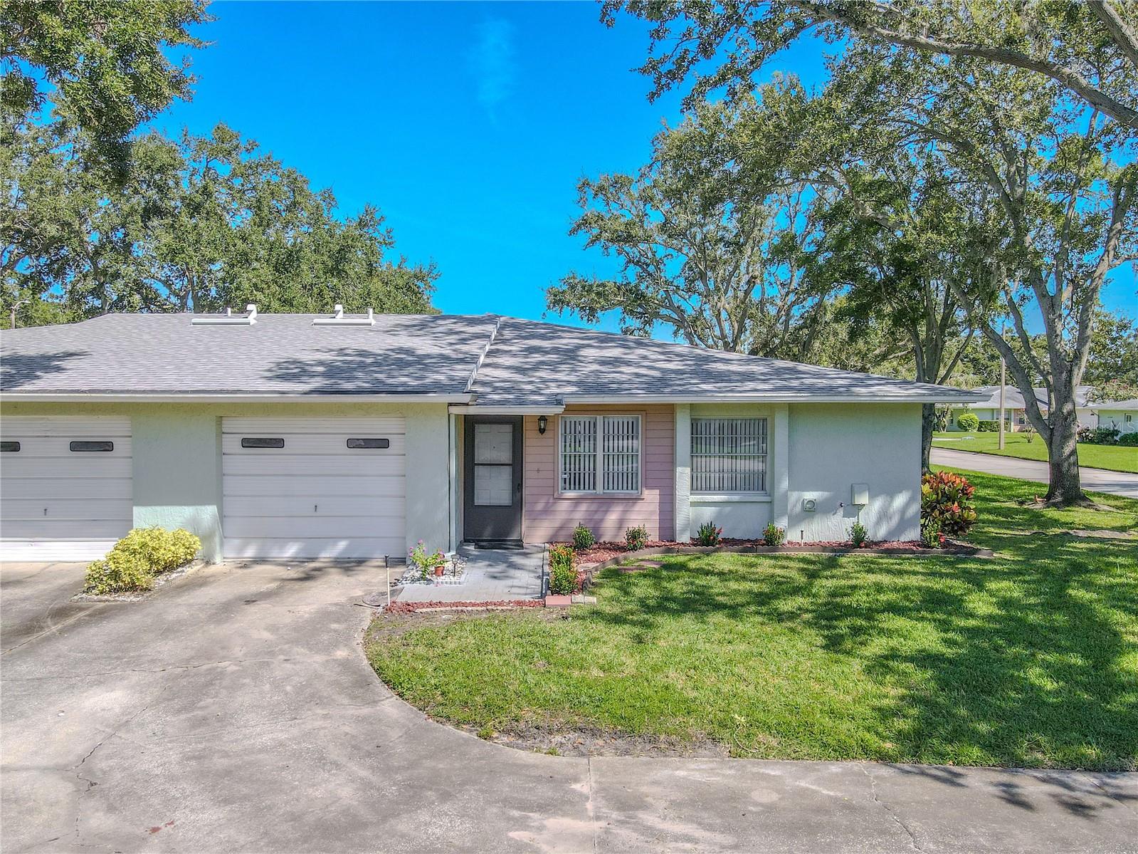 Welcome to this 2-bedroom, 2-bath villa in Palm Harbor, where comfort and opportunity meet in a highly desirable location.
The living room immediately sets a welcoming tone with abundant natural light, a ceiling fan with multi-bulb fixture, and neutral finishes that create an open, versatile backdrop. A built-in wall niche adds both character and function, providing an ideal spot for books, décor, or display pieces. From here, the layout transitions naturally into the adjoining kitchen and dining area.
The kitchen and dining share one open zone, designed for everyday convenience. While the cabinetry and counters reflect an earlier era, recent updates provide a valuable head start, including a stainless steel refrigerator (2024) and a range with oven (2025). A large illuminated ceiling panel ensures bright workspaces, while the compact footprint offers buyers the opportunity to tailor the space to their own taste and lifestyle.
A highlight of this villa is the private courtyard-style patio. Open to the sky and accessible from the living room, dining area, and garage, it creates a seamless blend of indoor and outdoor living. Whether enjoyed as a morning retreat, a garden space, or an area for evening relaxation, it is a versatile extension of the home.
Both bedrooms are generously sized, each featuring dual closets for ample storage. The primary suite includes a private bath with a step-in shower and sliding glass enclosure, along with a single vanity framed by an expansive mirror and overhead fluorescent lighting. Practical tile floors, built-in cabinetry, and direct proximity to the bedroom enhance its function while leaving room for modern updates.
The second bath serves both guests and the additional bedroom. Designed with a traditional tub-and-shower combination and tile surround, it offers everyday practicality and space for personalization. A single-sink vanity, framed mirror, and overhead fluorescent lighting complete the layout, providing a functional setting that awaits the finishing touches of its next owner.
The one-car garage includes attic access for additional storage, as well as an estimated 2022 washer and dryer for added convenience. A new roof in 2025 further enhances peace of mind, underscoring the property’s readiness for its next chapter.
Community amenities include a sparkling pool just steps from the villa, while the location places everyday essentials within easy reach, with Publix, Sprouts, and Trader Joe’s only minutes away. Outdoor enthusiasts will also appreciate proximity to Wall Springs Park, Pop Stansell Park, and John Chesnut Sr. Park, each offering trails, green space, and recreational amenities.
Combining a practical layout with thoughtful updates and an outstanding Palm Harbor address, this villa is ready for its next owner to personalize and enjoy. Schedule your private showing today and discover the potential this home has to offer.