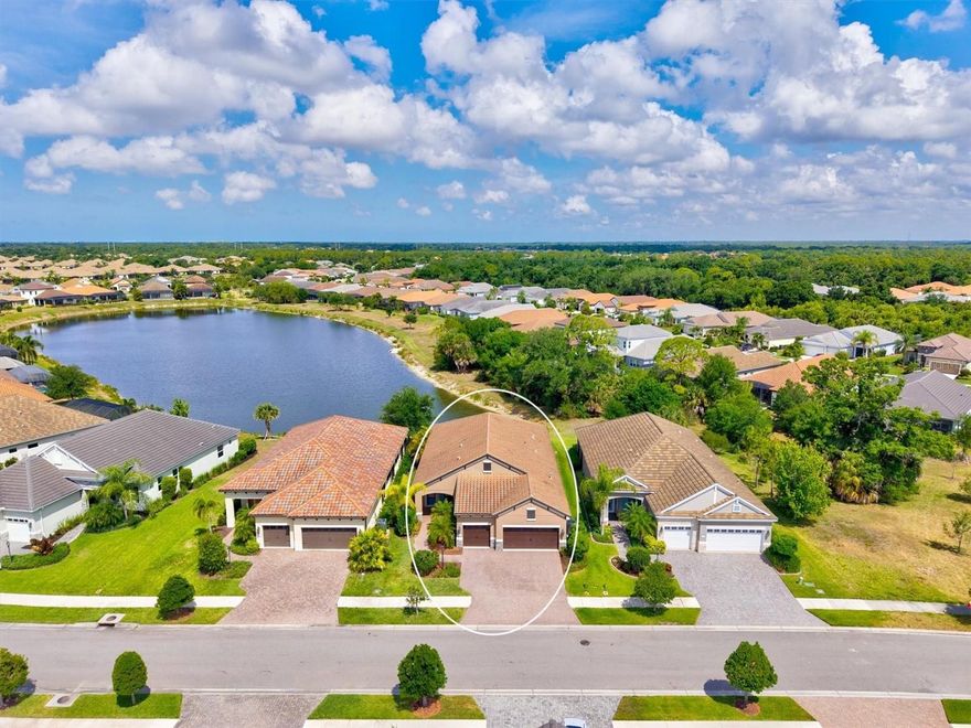 This beautifully upgraded Sea Mist model in Grand Palm delivers the perfect blend of luxury, privacy, and effortless Florida living. Set on a premium homesite, the home enjoys long water views with a preserve alongside. The extended lanai features SPF screens and sealed pavers.
A standout feature is the extended three-car garage with a four-foot extension, providing exceptional space and versatility. It is fully equipped with insulated doors, attic insulation, a built-in workbench and a mini split system.
Inside, the front glass entry door allows for a bright open layout. The kitchen impresses with glass-front cabinetry, a wood-paneled island, a California Closet pantry, stainless steel appliances and reverse osmosis system. The primary suite is a true retreat, featuring a tray ceiling, sweeping water views, dual walk-in closets with California Closet systems, and a spa-like bath with dual sinks and a spacious walk-in shower along with additional built-in shelving in the private water closet. The guest bedroom also offers a walk-in closet with California Closet shelving. A true highlight is the custom built-in office with engineered wood flooring, designed for productivity and style, paired with an oversized laundry room offering exceptional cabinetry and storage that elevates everyday living.
Additional upgrades include long plank tile flooring, custom draperies, added half bath, added linen closet shelving, whole-house EcoWater system and fresh exterior paint—making this home truly move-in ready.
Residents of Grand Palm enjoy an amenity-rich lifestyle surrounded 1000 acres, approximately 330 acres of preserved lakes, wetlands, and natural habitat, with trails and wildlife corridors woven throughout the community. A full-time activities director coordinates year-round events, clubs, fitness classes, and social programming, including pickleball, creating a true resort-style atmosphere.
Ideally located just minutes from I-75 for easy commuting and the vibrant shops, dining, and entertainment of Wellen Park, this home offers unmatched convenience alongside its serene natural setting.