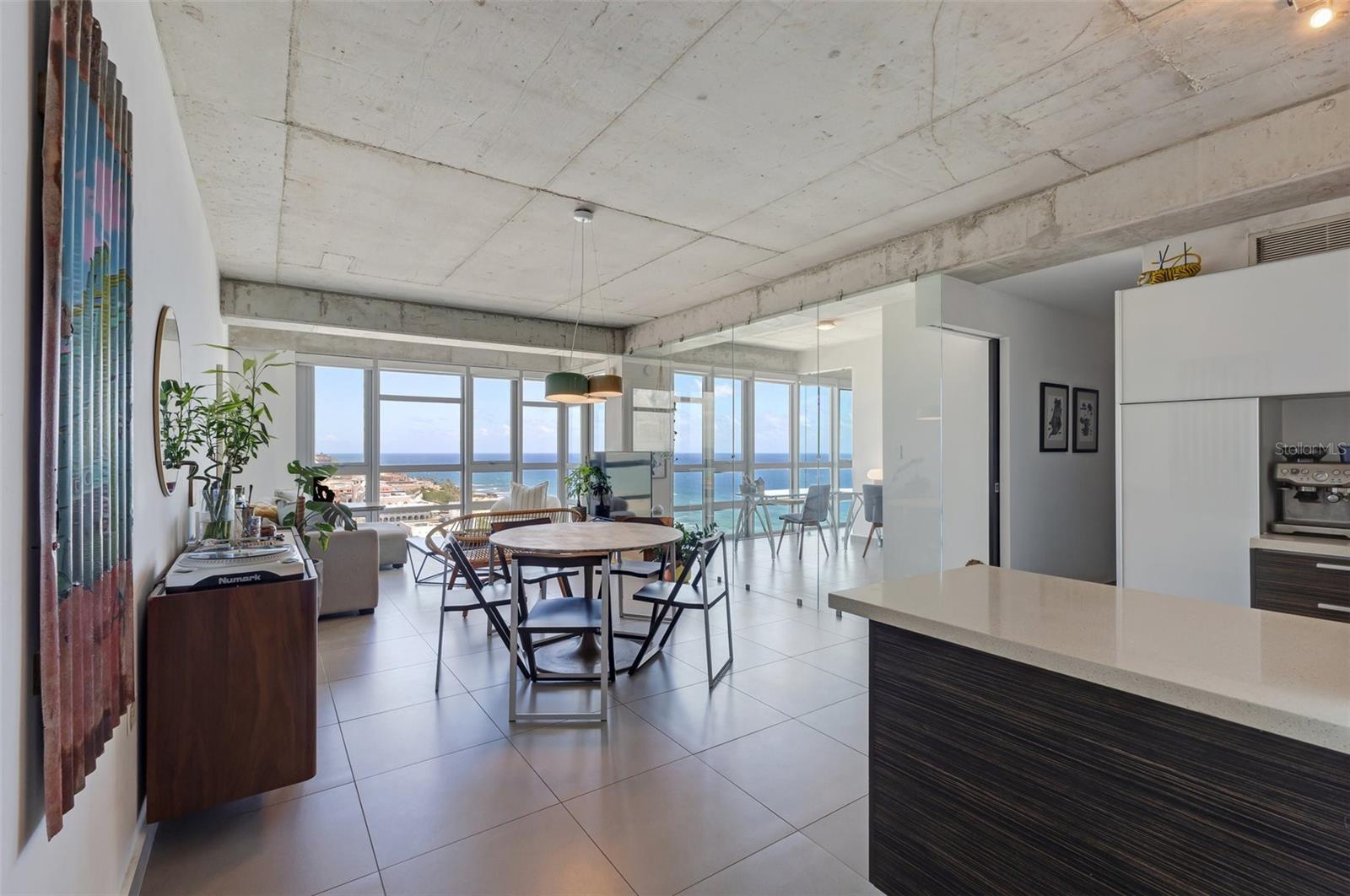 Truly turnkey residence and highest floor available in coveted Atlantis Condominium. Wake up to amazing panoramic views to the ocean and colonial Old San Juan, enjoy the convenience of a fully furnished and decorated apartment, freshly remodeled bathrooms, designer lighting, plus smart dimmers, thermostat and door lock that all connect to your phone. Primary suite features walk-in closet and spacious bathroom. Secondary bedroom can be used as an office or bedroom with wardrobe. Enjoy open concept living with kitchen, dining and family room all connected and great natural light from the floor to ceiling windows. Residence comes with glassware/silverware, large and small appliances, towels, linens, and everything you need to move-in with ease and convenience. In-unit laundry. 2 parking spaces (plus visitor parking).
Atlantis is close to everything, minutes from the park, stunning beach, boutiques, restaurants, and centric to the best nightlife in all of San Juan. Enjoy building amenities like a fully equipped gym, business center with WiFi, stunning events room, full power generators, water cistern, and 24/7 security.