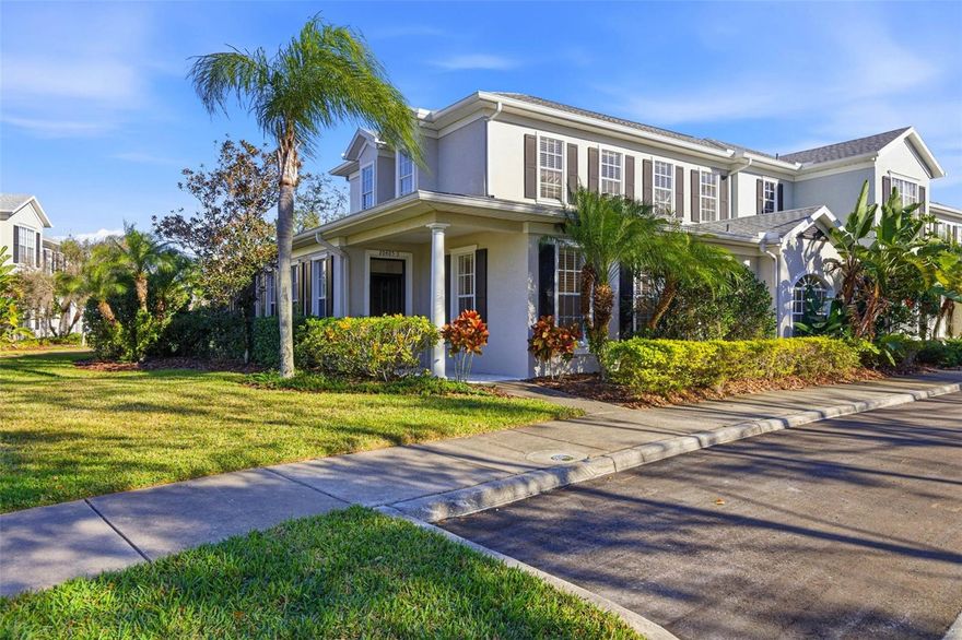 As you approach 20405 Club Vista Lane, #3, you are immediately captivated by lush Florida-Friendly landscaping that frames this elegant corner-unit townhouse within the gated community of Grand Hampton. Convenient guest parking sits just steps from the residence, while the covered front porch with recessed lighting sets a refined tone before you step inside. Upon entry, cascading natural light fills the home, highlighting the open floor plan and the updated luxury vinyl flooring that flows seamlessly throughout the main living areas, creating both warmth and durability. The foyer leads into a versatile bonus room, ideal for a home office, study, or den. Just down the hall, an updated half bath showcases a modern vanity and fixtures, followed by a spacious laundry room complete with upper shelving for added storage. The expansive primary bedroom, thoughtfully located on the first floor, offers comfort and privacy with a charming bay window and a generous walk-in closet. The updated primary en-suite feels straight out of a Pinterest board, featuring striking tile floors that extend into an oversized glass walk-in shower with an integrated soaking tub, dual-sink vanity with ample cabinetry, and sleek modern fixtures. The dining area is both stylish and functional, highlighted by a built-in pantry and dry bar complete with a wine fridge, wine rack, and decorative tile backsplash. Flowing effortlessly from the dining space, the kitchen impresses with recessed lighting, 42” white cabinets with crown molding, quartz countertops, and a gorgeous tile backsplash. Stainless steel appliances—including cooktop, range, dishwasher, refrigerator, and microwave—are complemented by a range hood vented to the exterior and a water filtration system. An eat-in counter space connects naturally to the living room, where updated luxury vinyl flooring continues underfoot and endless natural light pours in through sliding glass doors equipped with plantation shutter sliders. These doors open to a covered, screened side porch, perfect for alfresco dining or relaxing in the Florida breeze. This completes the main floor. Ascending the staircase, you arrive at an expansive loft offering ample space for an entertainment area, home gym equipment, or additional lounging, along with a convenient storage closet. Bedrooms two and three are also located on the second floor and share a beautifully updated full bath featuring barn-style glass sliding shower doors with a bench, a striking vanity with stone countertop, and modern fixtures. Notable updates include a roof approximately 3 years old, AC (2020), water heater (2022), epoxy garage flooring, and dishwasher, disposal, microwave, range, and oven all approximately 4 years old. The HOA fee includes roof maintenance, building exterior maintenance, ground maintenance, and internet. The Grand Hampton community provides a wealth of amenities, including a 24-hour manned gate, a state-of-the-art clubhouse, fitness center, playgrounds, lake access, and heated pools—including a lagoon-style pool with slide and a dedicated lap pool. Residents also enjoy tennis courts and basketball courts. Conveniently located near I-75 and I-275, with easy access to Advent Hospital, PHSC, AdventHealth Center Ice, The Shops at Wiregrass, and Tampa Premium Outlets.