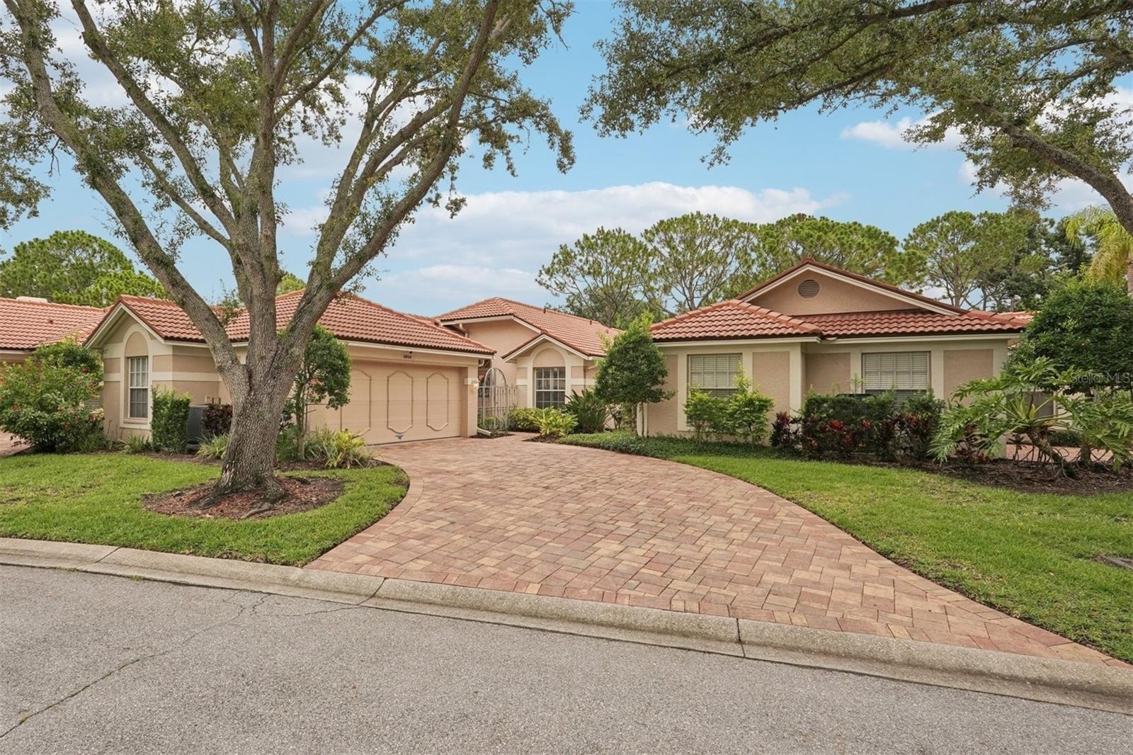 Welcome to Lyndhurst Court in The Meadows —where you’ll enjoy peaceful, maintenance-free living with no CDD fees! As you arrive, a serene, tree-lined canopy welcomes you into this beautifully located home. Inside, soaring vaulted ceilings and large clerestory windows bathe the space in natural light, complemented by elegant Hunter Douglas window treatments and plantation shutters. The open living area features a granite wet bar—perfect for entertaining—and sliding glass doors from the living room, kitchen, and primary bedroom that open to a spacious screened lanai overlooking stunning golf course and green space views. A brick paver driveway, walkway, and side garden, along with pavers throughout the screened porch, add stylish outdoor appeal. The updated kitchen boasts Corian countertops, a water purification system, and a removed wall that now creates a more open flow to the living area. Step outside the eat-in kitchen to dine al fresco under the portico in your private garden. The primary suite offers a luxurious retreat with a completely renovated bath featuring custom cabinetry, a large seamless glass shower with built-in body sprays, and a separate Kohler hydro-massage tub. Guests will enjoy a fully updated second bath complete with a top-tier American Standard jetted walk-in tub with aromatherapy. The oversized garage includes ceiling-mounted custom storage. Additional highlights include a 2019 new A/C with AeroSeal and a transferable maintenance contract through 2026, a 2022 Samsung refrigerator and new garbage disposal, a 2024 garage door tune-up, and fresh entryway landscaping in 2025. You’ll love the privacy, spacious feel, and gorgeous backyard views—not to mention the heated, caged community pool, just steps away. The Meadows Community includes the Wellness & Fitness Center, 17 clay tennis courts, 8 pickleball courts, and a Junior Olympic-size heated pool. With close proximity to Trader Joe’s, Whole Foods, Fresh Market, UTC Mall, Benderson Park, and miles of walking paths, fitness center, and other amenities within The Meadows, this home offers comfort, style, and convenience. Schedule your showing today!