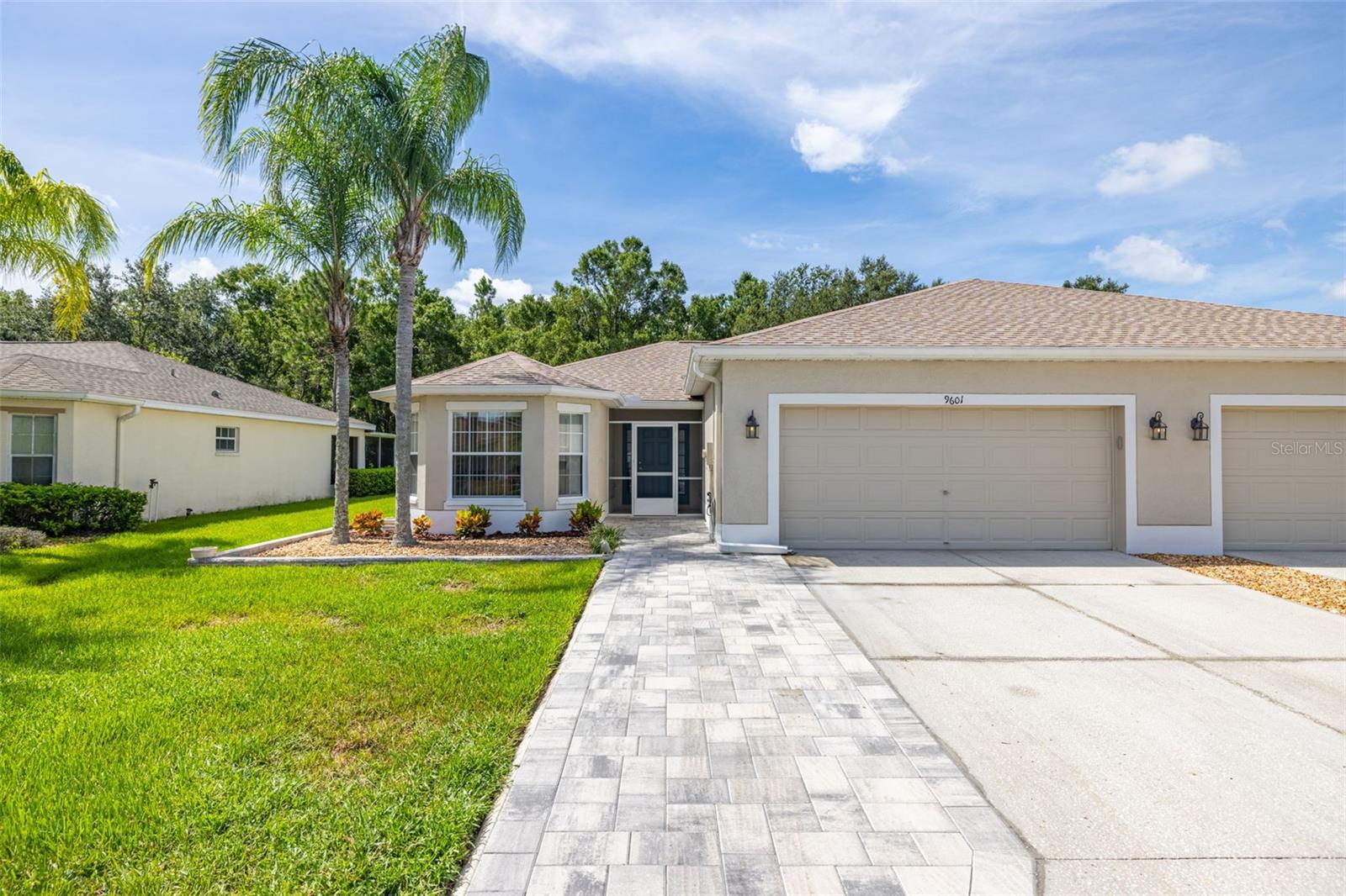 UPDATED, MOVE-IN-READY, MAINTENANCE-FREE VILLA ON A PRIVATE CONSERVATION LOT IN A PREMIER 55+ GATED RESORT-STYLE GOLF COMMUNITY! An open greatroom floor plan, formal dining room, 3 bedrooms, 2 full bathrooms, 2 car garage, and a backyard screened-in lanai! Great curb appeal, new landscape, new paved expanded driveway, walkway, & a welcoming screened-in front porch entry! Newer luxury vinyl & tile flooring, vaulted ceilings, ceiling fans, blinds, energy efficient double pane windows, some new interior paint, & double sliding doors that lead out to the screened-in lanai with a peaceful nature lovers view of the woods, also bringing in plenty of natural light! The eat-in kitchen offers stainless appliances, wood cabinets, granite countertops, a closet pantry, & a breakfast bar! The spacious main bedroom has a large walk-in closet and an ensuite bathroom, a tiled shower with a bench seat, dual sinks, a high vanity, granite counters, and new tile floors! Your visitors will love the two quaint guest rooms, one with a bay window, which could also be a great den/office! A roof replacement in 2024, a new water heater, and an inside laundry with a huge pantry for extra storage, washer/dryer included! Tampa Bay Golf And Country Club has fantastic amenities, a clubhouse with an event center, restaurant, bar & grill with outside patio seating, entertainment, 2 pools, fitness center, tennis, pickleball, billiards, library, community center, cards, and many other clubs, golf pro shop, and more! SCHEDULE YOUR SHOWING TODAY!