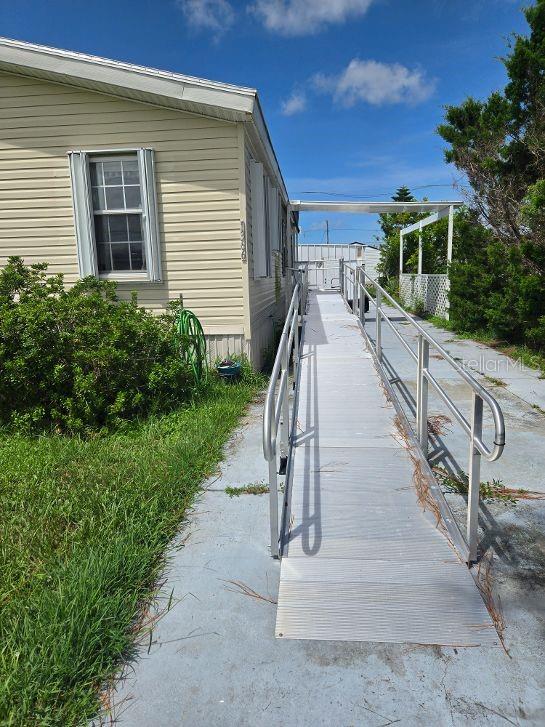 This is one of the rare finds in a 55 and older community. It has three bedrooms, two bathrooms, with large open living room, dining room and kitchen. It also has an all-aluminum ramp for wheelchairs or moving thing in or out of the home. You will have extra safety with the hurricane shutters. There is new air conditioner installed 2025. This home is in a centrally located neighborhood with Stores, Doctors, Restaurants, Golf courses, Boating and only three miles to the beautiful beaches on the Gulf of America. There is a club that you may join that has many activities, and for a small fee use the boat launch with the waters that lead to the Lemon Bay and to the Gulf. Come and enjoy our bit of paradise with us.