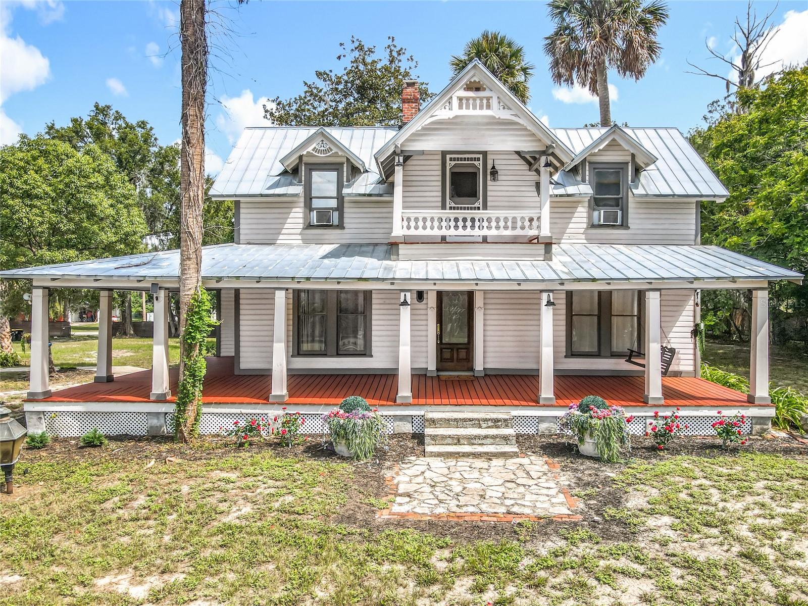 Take A Page Out Of History And Experience The Timeless Beauty Of This Amazing 1886 Historic Home, A Landmark In Orange City’s Past. This Property Welcomes You With A Row Of Towering Palms, Once Guiding Horse-Drawn Carriages To The Home. The Grand Wraparound Porch, Multiple Screened Sitting Areas, And Upstairs Balcony Invite You To Enjoy The Peaceful Views Of This Property On 1.76 Acres. Every Corner Of This Residence Tells A Story, From The Handcrafted Woodwork To The Many Fireplaces. Stepping Through The Front Door Into The Foyer, You Can Head Right Into A Beautiful Light And Bright Room With One Of The Home’s Many Fireplaces. The Most Recent Owners Used This As Their Primary Suite, But It Would Also Make A Wonderful Sitting Room Or Office. To The Left, You’ll Find The Living And Dining Rooms. The Living Room Has A Beautiful Cozy Fireplace, And The Dining Room Features Built-Ins, Another Fireplace, And Large Windows That Let The Sun Pour In. The Spacious Kitchen Sits Just Off The Dining Room And Features Stainless Steel Appliances And A Walk-In Pantry. From The Kitchen, A Backdoor Takes You Out To A Screened Porch And A Charming Little Garden. Use The Beautiful Staircase At The Front Of The Home To Take You Up To The 2nd Floor, Where You’ll Discover The Primary Suite With A 6x16 Walk-In Closet, Soaking Tub, And An Additional Bedroom Across The Hall. One Unique Feature Of This Home Is The Back Entrance, Located Off The Kitchen And Screened Porch. From Here, You Can Head Straight Up To The Third Bedroom On The 2nd Floor Without Going Through The Main Living Areas. This Setup Could Be Perfect For Someone Who Works From Home, Wants A Private Office, Or Needs A Separate Space For Guests. The Detached 2-Car Garage With An Electric Charging Station Shows That Even A Home From The 19th Century Can Keep Pace With The Future. This Home Is Centrally Located, And Close To Everything — Shopping, Restaurants, Medical Facilities. Only 2.5 Miles From Blue Spring State Park, Known As The Winter Home To Manatees, 6.4 Miles From Downtown DeLand (Once Voted America's Best Main Street), 28 Miles From New Smyrna Beach, 30 Miles From Downtown Orlando, And Just 5 Miles From I-4.