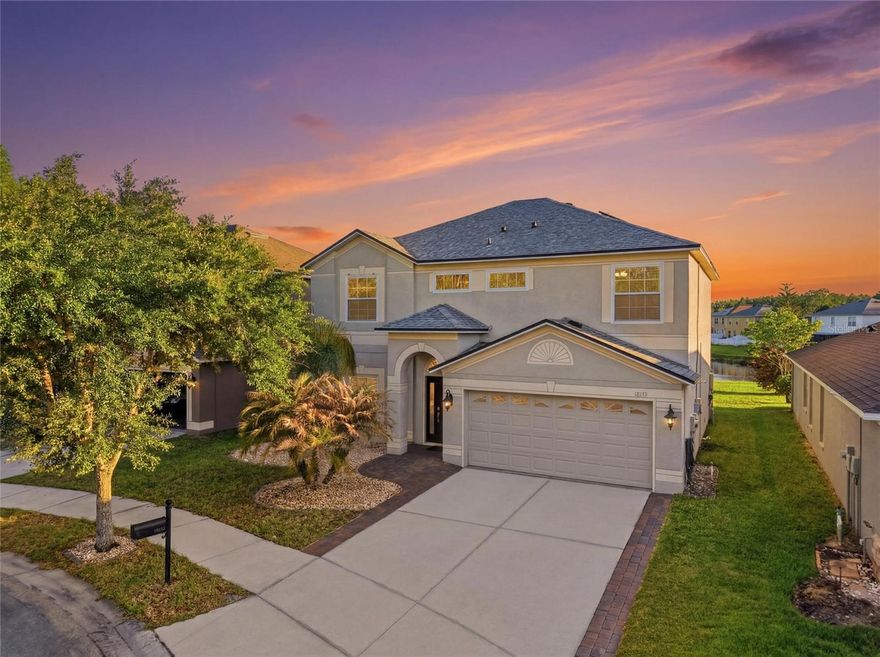 Welcome to resort-style living in the highly sought-after gated golf course community of Heritage Isles in New Tampa. Tucked away on a peaceful cul-de-sac with breathtaking water views, this beautifully upgraded 4-bedroom, 2.5-bath home offers the perfect blend of luxury, comfort, and lifestyle.
From the moment you step through the front door, you’re greeted with elegant formal living and dining spaces, rich flooring, plantation shutters, and stunning sightlines that lead straight through to the sparkling pool and tranquil pond views beyond. The heart of the home features an updated kitchen with beautiful backsplash details, stainless steel appliances, ample cabinetry, and seamless flow into the spacious family room showcasing a custom shiplap accent wall, floating entertainment cabinetry, and a built-in bar area designed for entertaining.
Step outside to your own private backyard oasis featuring a heated saltwater pool and spa with fountains, lighting, in-water lounge seating, and an expansive panoramic screened enclosure overlooking the water. The outdoor living space is truly exceptional, complete with a built-in summer kitchen with grill, refrigerator, shelving, bar seating, TV area, and even a personal putting green for enjoying the Florida lifestyle year-round. Solar panels help keep electric costs and pool heating expenses impressively low.

Upstairs, the oversized primary suite offers beautiful water views, dual vanities, a relaxing garden tub, walk-in shower, and spacious walk-in closets. The additional bedrooms are generously sized, with several also enjoying peaceful water views. Additional highlights include an upstairs laundry room for convenience, built-in garage storage cabinetry, and a Tesla charging station already installed in the garage for added convenience and modern living.

Located in the amenity-rich Heritage Isles community, residents enjoy access to an 18-hole championship golf course, clubhouse with restaurant, resort-style pool with waterslide, fitness center, tennis courts, basketball courts, playgrounds, and beautifully maintained grounds. Conveniently located near top-rated schools, shopping, dining, Wiregrass Mall, Tampa Premium Outlets, and major highways, this home offers the perfect combination of everyday convenience and upscale Florida living.