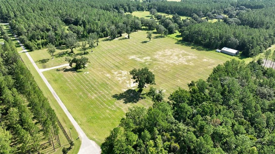 Nestled within Long Pond Plantation, a gated deed-restricted community, this 10.71 acre agricultural parcel is zoned A1 and offers versatile possibilities such as farming, equestrian activities, or livestock raising. Long Pond Plantation's beautiful gated entrance features tasteful landscaping and stunning magnolia trees, making an impeccable first impression for visitors and residents alike. With a private road and electricity access, this parcel provides an ideal canvas for building your dream home or establishing a functional farmstead. Immerse yourself in the charm of countryside living, strategically located between Ocala and Gainesville. For equestrian enthusiasts, the convenience is unrivaled – just 15 minutes from the World Equestrian Center, 12 minutes from HITS, and 4 minutes from Sweet Dixie South. Property has now been perimeter fenced with wire and top board.  New pics to follow