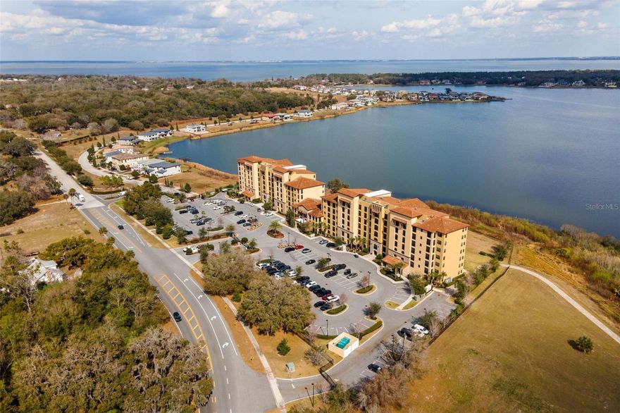 Siena at Bella Collina – Lakefront Luxury in Montverde

Nestled among the rolling hills of Montverde, this exceptional three-bedroom, three-bathroom lakefront residence in Siena at Bella Collina offers an elegant blend of privacy, sophistication, and resort-style living. Encompassing approximately 1,568 square feet of interior space plus a private screened balcony, the home showcases tranquil views of Lake Siena.

The thoughtfully designed open-concept floor plan captures water views from the living room, dining area, kitchen, and primary suite, creating a seamless indoor-outdoor experience. Refined finishes include porcelain tile flooring in the foyer, kitchen, laundry room, and baths, crown molding, tray ceilings, and 5½-inch baseboards throughout.

The gourmet kitchen is appointed with quartz countertops, 42-inch designer cabinetry, and a Frigidaire stainless-steel appliance package featuring a French-door refrigerator and glass-top range. The lakeview primary suite offers a spacious walk-in closet and a spa-inspired bath with dual vanities and a frameless glass-enclosed shower.

Two additional bedrooms—each with access to a full bath—provide flexibility for guests, family, or a home office. The screened balcony serves as a peaceful retreat, ideal for enjoying morning coffee while overlooking the water.

Residents of Siena enjoy exclusive access to a heated lakefront pool with cabanas, barbecue area, and fire pit, along with a 24-hour fitness center and conference room. Monthly dues include cable, internet, water, and nightly security.

Optional membership at the Club at Bella Collina offers access to two on-site restaurants, a full-service spa, and pay-to-play golf on the Nick Faldo–designed course. Located within a gated community just minutes from Montverde Academy, with convenient access to the Florida Turnpike, State Road 429, and 408, this residence offers effortless connectivity to downtown Orlando, Winter Garden, and Clermont.

Experience the Bella Collina lifestyle—where luxury, comfort, and natural beauty come together in perfect harmony.