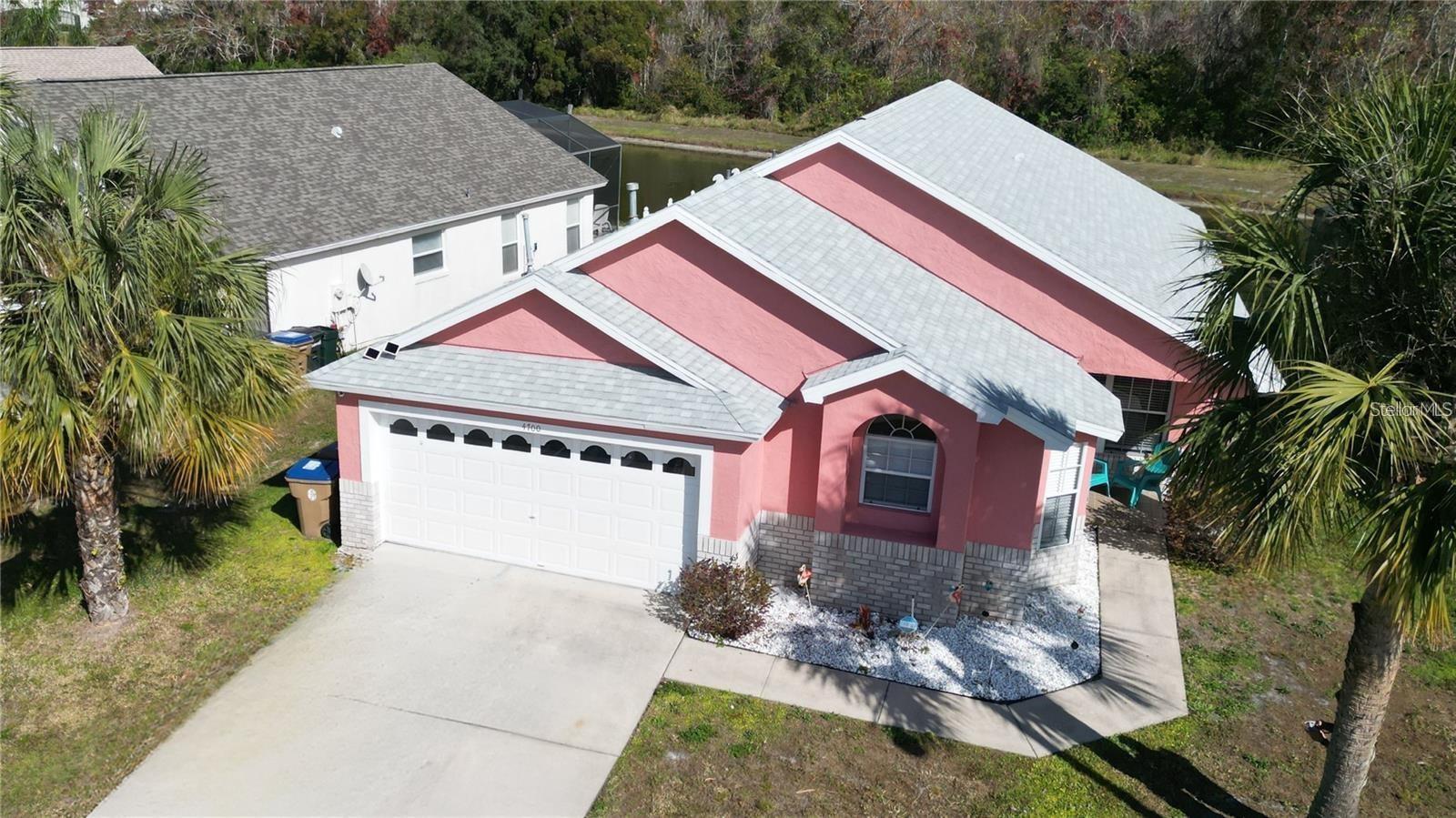 This beautiful and cozy family vacation home is just 20 minutes from the parks—a perfect retreat whether you're looking for a personal residence ! a fully remodeled and move-in ready 4-bedroom, 2-bathroom single-story ranch offering 2,359 square feet of upgraded living space on a 6,229 SqFt lot. Completely furnished with stylish, modern décor, this home is turn-key and packed with upgrades, including new appliances, new water heater, and fresh paint inside and out. The kitchen features granite countertops, while each bedroom is enhanced with new blinds and curtains. The queen bedroom includes an adjustable bed, and all living spaces are designed for comfort and style. Step outside to enjoy a private, screened-in heated pool with new lights and a child safety fence, set against a serene pond view with no rear neighbors