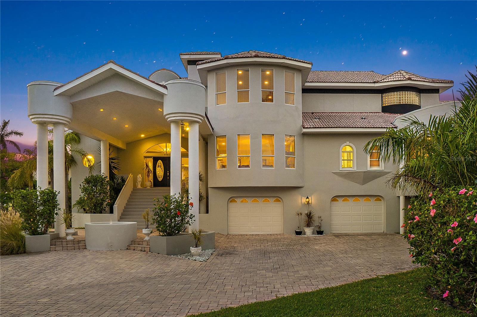 MAJOR PRICE IMPROVEMENT! We are HIGH AND DRY in this majestic, elevated, custom built home by Matta. Located on the highly desirable Columbus Drive in Tierra Verde! Feel peace of mind as you approach this massive solidly built home - where the 5155 sq ft of living area starts on the second floor. Soak in the additional 2600 sq ft of lush outdoor space with views of the Gulf and a WHOPPING 3424 sqft garage situated under the living area. As you approach this property, take note of the grand portico that leads to the welcoming entrance and the over 3000 sq ft of paver driveway. Enter through the stately glass doors you will immediately appreciate the soaring ceilings of the open great room with water views through the expansive windows that provide an abundance of natural light. This spacious family room is perfect for large gatherings or a quiet night at home and features a beautiful marble clad fireplace offering warmth and ambience. Walk past the elegant formal dining room onto the kitchen that is fit for a chef! Featuring 2 enormous islands- one for bar seating and the other one for cooking, granite countertops, newer appliances, eat in dining area that is steps to the outdoor covered deck for dining alfresco! The kitchen also overlooks a bright and open family room which extends the entertainment space or can serve as a quiet respite. The first floor also has three well appointed ensuite bedrooms that have their own outdoor space to make your guests feel right at home! The main level also features a spacious laundry room, half bath, lots of storage and a “ready to install” elevator shaft reaching all levels of the home. A beautiful curved oak and glass staircase will take you to the second level where you will find a cozy loft area overlooking the great room. Continue on to a huge (over 700 sq ft) office but could be reinvisioned into a game room or study? It is also plumbed- think wet bar, small kitchen or a possible multifamily area, perhaps? Onto the impressive Owners bedroom retreat, which offers plenty of privacy and luxury as well as an extensive walk in closet of your dreams. Walk out onto your private covered patio and enjoy the views of the Gulf and sunsets. You will be blown away at the massive Owner’s bath (over 500 sq ft!) featuring a palacios sunken jacuzzi tub, spacious walk-in shower and double vanities. Let’s talk about the garage. Situated under the living area of the home elevating it and encompassing over 3400 sq ft - you will be the envy of the neighborhood! PLENTY of storage for your vehicles, island toys etc. NOTE -garage did not have any water intrusion from the 2024 storms. The .33 acre lot is located on the west side of the highly desirable Columbus Drive but is still off the water. With its lush tropical landscaping and views of the Gulf, it also offers plenty of room to build the pool/backyard oasis of your dreams, if you desire. Tierra Verde is a wonderful place to call home. It has some of the top restaurants in St Pete , 2 marinas, Fort De Soto Park and a special community of neighbors and friends. Tierra Verde is also situated close to the beaches of St Pete (10 min), Downtown St Pete (10Mins), airports, shopping and easy access to I275 which will take you anywhere you want to go - but why would you ever want to leave? This slice of paradise is a MUST SEE. Schedule your private tour today!