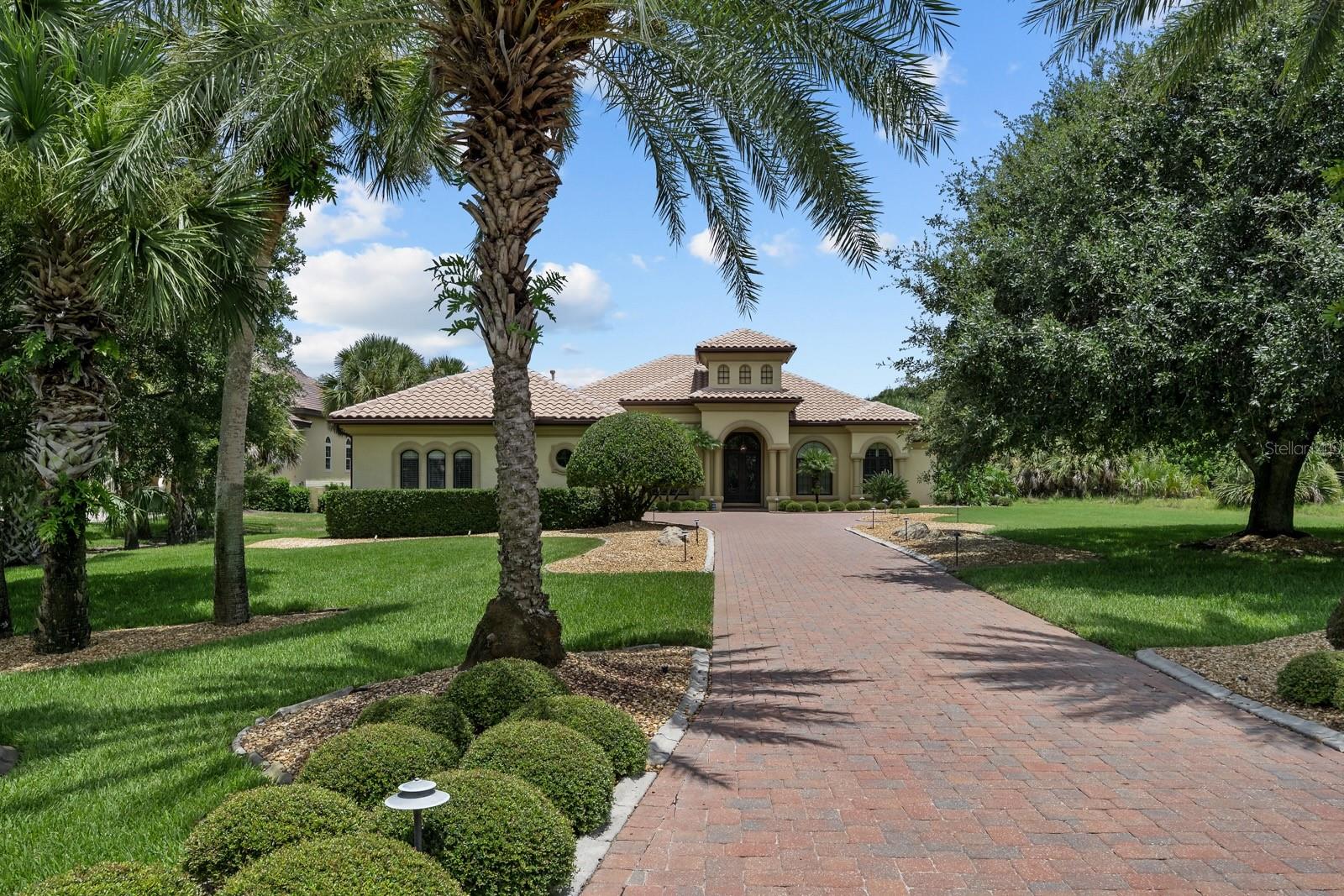 Custom-built Island Estates home with private dock, saltwater pool, and a stunning, built-in waterfall that serves as the focal point of the great room, blending art and nature to create a peaceful, luxurious atmosphere. Located on 1.2 acres in the exclusive gated community of Island Estates, this well-maintained, custom Arthur Rutenberg home (built by Country Club Homes in 2005) offers the perfect blend of coastal elegance and comfort. With 3 bedrooms, 4 full baths, and over 4,150 sq ft of living space, this one-owner home is thoughtfully designed and richly appointed. The spacious primary suite features two separate, full bathrooms and dual walk-in closets. A private office/den with built-ins provides a quiet workspace, while the open-concept living area includes a gas fireplace, polished travertine floors, and abundant natural light.
The gourmet kitchen is the heart of the home, complete with granite countertops, a large center island, gas cooktop, built-in microwave, wine refrigerator, and skylights that fill the space with sunshine. Step outside to a true Florida oasis: a screened lanai with saltwater pool and spa, outdoor kitchen, and paver patio—perfect for entertaining or relaxing. The beautifully landscaped grounds features lighted paver walkways, and a covered boat dock along the Fox Cut, offering direct access to the Intracoastal and beyond. Additional highlights include: Oversized 3-car garage with epoxy floors and cabinet storage, whole-house generator and buried propane tank, storm shutters and impact glass on front windows, Carrier A/C units (5 & 5.5 ton, 4–5 years old), saltwater pool system with new pump/heater (2022), gas fireplace, hot water heater (2 yrs old), 8’ solid core doors, 10’ ceilings, walk-in closets and a water softener system. Private resident beach access just steps away. This exceptional Island Estates property offers luxury coastal living and beach access—an ideal retreat for full-time or seasonal living. Island Estates is part of the larger oceanfront, gated community of Hammock Dunes in Palm Coast, FL. Plus, you’re conveniently close to the ocean, St. Augustine, Daytona Beach, and Jacksonville.