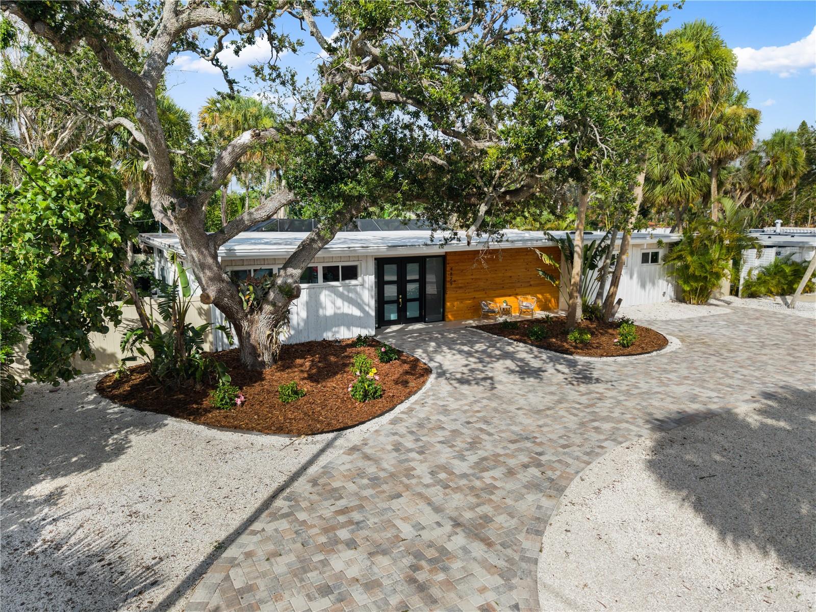 Own a Rare Piece of Sarasota's Architectural History on Siesta Key! Step into timeless design and architectural significance with this rare mid-
century modern masterpiece, situated on a private double lot in the heart of Siesta Key. Originally crafted in 1957 by Frank Coleman and Tollen Twitchell, two influential figures in the Original Sarasota School of Architecture, this home seamlessly blends historical character with modern luxury. Boasting 2,500 square feet of light-filled living space, this 4-bedroom, 3-bathroom residence has been meticulously renovated while preserving its original architectural integrity. Clean lines, expansive impact windows, and an open floor plan define the home’s iconic style, inviting the outdoors in and creating a sense of calm sophistication throughout. Inside, the split floor plan provides distinct zones for privacy and connection. The primary suite is a sanctuary of its own, complete with private access to the outdoors, a luxurious bath featuring a freestanding soaking tub, and a marble-lined walk-in shower. On the opposite side of the home, three additional guest bedrooms provide comfort and style—including a junior suite with its own private bath, full marble detailing, and oversized picture window with views of the pool and deck area. High-end renovations include: New commercial-grade roof (30-year lifespan); High-impact windows and doors throughout the home; Durable wood-grain tile flooring; Quartz waterfall countertops & custom wood cabinetry in the kitchen; Floor to ceiling marble tile in all bathrooms; All new major appliances including HVAC, pool equipment and water heater; Spray foam insulation throughout the home for an extra layer of protection; and designer finishes and curated lighting throughout. Step outside to your personal paradise: a heated saltwater pool with screened enclosure, surrounded by lush tropical foliage for complete privacy and serenity. The home is ideally located just blocks from Roberts Bay and less than a mile from the award-winning crystal sands of Siesta Key Beach. A true retreat, the lushly landscaped double lot offers unmatched privacy and space—perfect for entertaining or simply relaxing beneath the tropical canopy. Whether you're a collector of architectural homes, a beach lover, or simply someone looking for the rare blend of heritage, location, and luxury, this one-of-a-kind property is your opportunity to own an iconic piece of Sarasota’s rich design legacy. House sits on a DOUBLE LOT - ADU build-out available for investors looking for value-add and additional income potential.