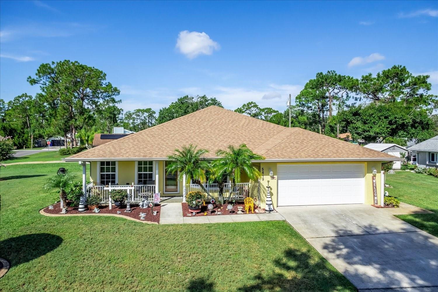 Step into the charm of this classic, storybook home, where comfort meets timeless style. With over 1,600 sq. ft. of living space, this 3-bedroom, 2-bath beauty welcomes you with warm engineered hardwood floors, plush carpet in just two bedrooms, and a layout designed for easy, relaxed living. Imagine afternoons on the inviting front porch in this quiet neighborhood, just a few blocks from the serene waters of Lake Huckleberry. The kitchen is the true heart of the home, rich wood cabinets, quartz countertops, and beautiful wraparound counters create both function and style, while offering the perfect setting for gatherings and entertaining. Step out back to a paved and covered porch, ideal for morning coffee, while enjoying the peaceful privacy of a fully fenced backyard. The corner lot (.23 acres) also offers a charming shed and plenty of green space. Lovingly maintained and brimming with a cozy, cottage-like feel, yet still within city limits, this home offers the perfect balance of tranquility and convenience. This isn't just a house, it's a place where life feels just right.