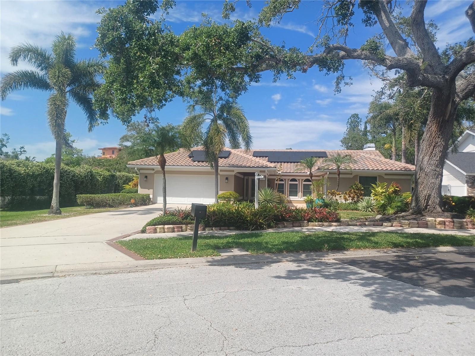 Recreation, Privacy, Multiple Garages! Located in the quiet Kensington Oaks neighborhood, you are five minutes to catch sunsets at Indian Rocks Beach. This 2,765 sq.' open concept home features 3 bedrooms, 2 baths with a 3 rd. full bathroom for guests near the screened swimming pool. As you walk from the outdoor kitchen, the covered lanai leads to the custom built 864 sq.' climate-controlled garage. There are 3 bays with 2 lifts and an air compressor system. This space may be converted to an office, recreation area, workshop, etc. Additionally, there is an attached 2 car garage at the south facing front of the home. Multiple solar panels, a sum pump, a Generac Generator, Travertine Floors, hurricane windows, granite countertops, stainless steel appliances and pavers add quality features to this Mediterranean style home. The annual HOA is $850, which includes great neighbors, garbage, recycling and yard debris pick up. There was no water damage to this property from the hurricanes in 2024.