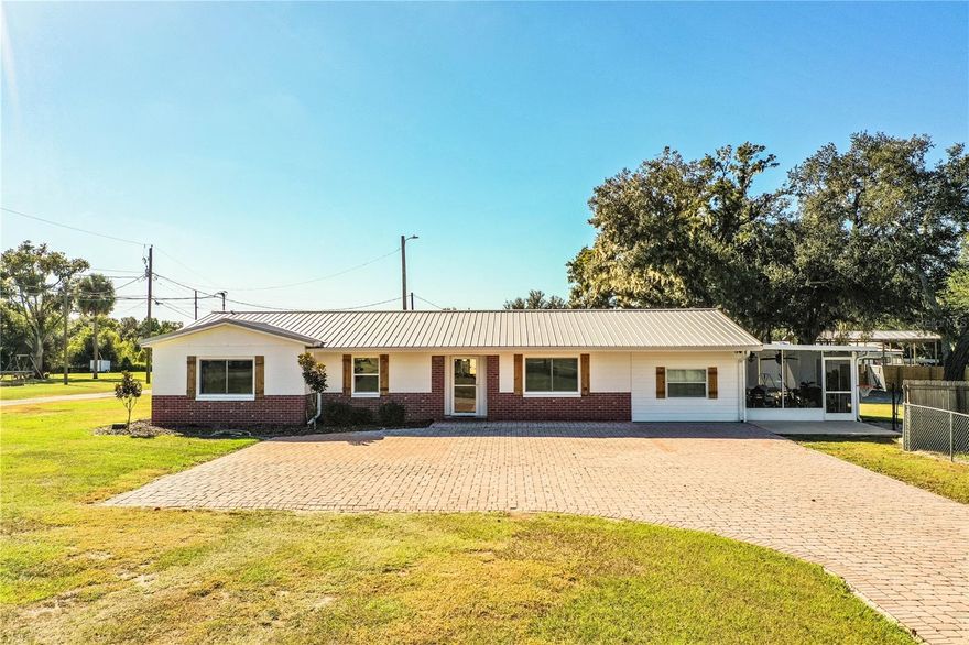 DO NOT DRIVE PAST GATE INTO PRIVATE DRIVEWAY WITHOUT AN APPOINTMENT! MOTIVATED SELLERS. Welcome home to this updated 4-bedroom, 2-bath home on over an acre of high and dry land with no HOA. Ideally located just minutes from Highway 60, this property offers privacy and quick access to Lakeland, Bartow, and Winter Haven. A paved driveway, private entrance gate, and fully fenced yard provide a welcoming and secure entry, with plenty of space for parking, a boat, heavy equipment, toys, or an RV. Inside, beautiful original hard floors run through the main living areas, kitchen, dining room, and all bedrooms. The kitchen was refreshed in 2025 with shaker cabinets, a large prep island, and recessed lighting. The dining room opens to the rear porch and patio, perfect for outdoor living with a second screened porch off the fourth bedroom, providing a private outdoor retreat.. Major improvements include a lifetime metal roof (2013), Rheem 3.5-ton A/C (2016), new windows and doors (2022), full interior remodel (2022), 150 sq. ft. office (2023), updated bathrooms and appliances (2023), back porch and playground (2023), well pump and smart water heater (2024), a 40’ x 60’ x 16’ shop with 200-amp service and new Leveton panel (2024), exterior lighting (2025), new gutters on home and shop (2025), and a new privacy fence and gate (2025). Additional features include a security surveillance system and ample outdoor space for projects or hobbies. This property combines modern updates, practical amenities, and plenty of room to enjoy the outdoors.