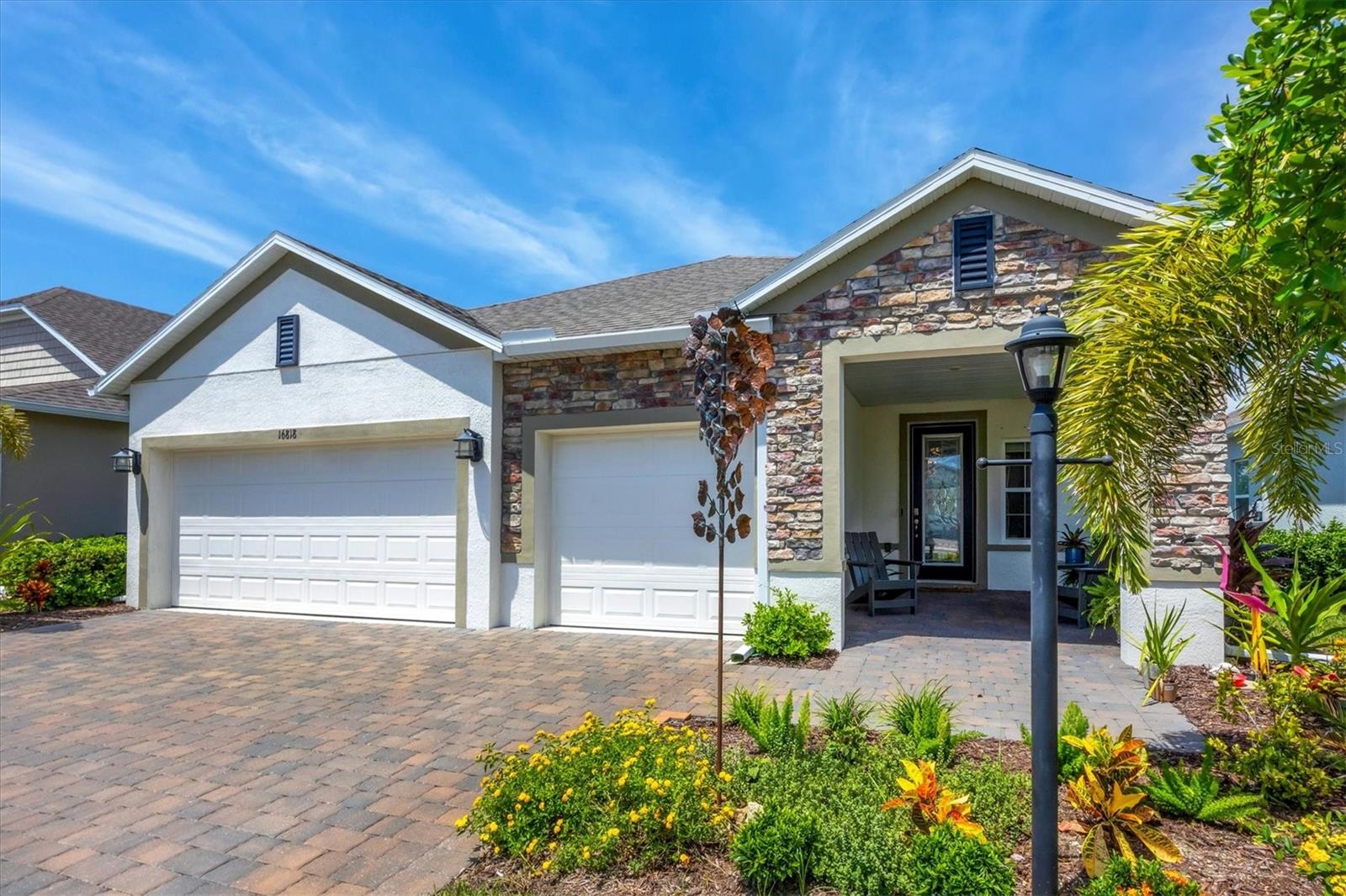 Stunning West Port Home with 3-Car Garage & Water Views! Why wait to build when this better-than-new Ashton model by Maronda Homes is available now in the highly desirable West Port community? Featuring 3 bedrooms, 2 bathrooms, and a rare 3-car garage with ceiling storage, this home offers the perfect blend of style, function, and upgrades. Inside, the open-concept floor plan features a chef-inspired kitchen with stone countertops, shaker-style cabinetry, custom lighting, a large island, and stainless steel appliances. The primary suite is a private retreat with a walk-in closet, dual vanities, and a beautifully upgraded walk-in shower with water views. Two spacious guest rooms are arranged in a split plan for added privacy, while the bathroom is well-appointed with a tub/shower combination and a tile surround. Upgrades continue throughout, featuring a built-out laundry room with soft-close cabinetry, a paver driveway, full hurricane protection, and an X-FLOOD ZONE location for added peace of mind. Step outside to your covered lanai overlooking the water, perfect for enjoying breathtaking Florida sunsets. West Port offers over 450 acres of amenities, anchored by Centennial Park, which features a brand-new aquatic center, soccer fields, an 18-hole disc golf course, playgrounds, and miles of biking and walking trails. All with low HOA fees and just minutes to shopping, dining, healthcare, Charlotte Sports Park, and Gulf beaches. This upgraded Ashton model is a rare opportunity in West Port. Don’t miss out, schedule your showing today.