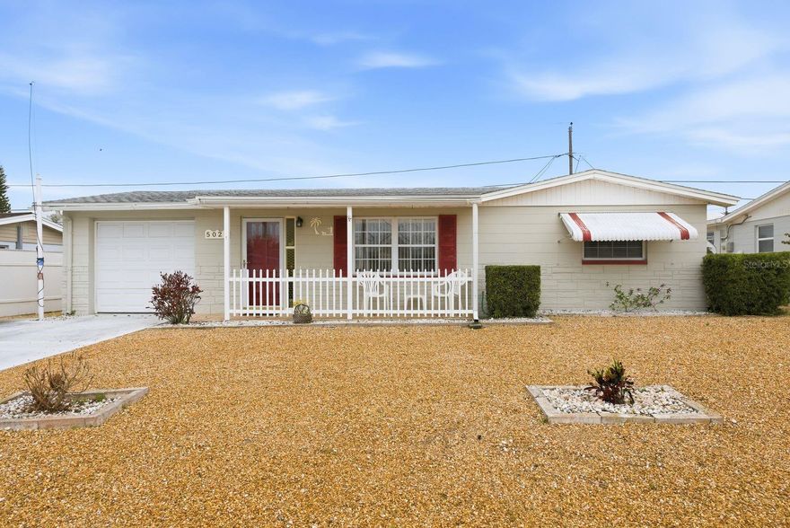 Welcome to this well-maintained two-bedroom, two-bathroom home tucked away on a quiet cul-de-sac in Holiday. With a wide driveway, inviting front porch, and thoughtful updates throughout, this home offers both comfort and convenience. Major improvements include a 2022 roof and a 2021 A/C and water heater, providing peace of mind for years to come. Inside, you’ll find classic terrazzo flooring, an open floor plan, and ceiling fans throughout, creating a light and comfortable living space. The front living room flows seamlessly into the kitchen and dining area, making it ideal for everyday living and entertaining. The kitchen features a center island perfect for meal prep or casual dining, matching appliances, and a dining area just off the kitchen. Toward the back of the home, a heated and cooled sunroom offers additional living space - perfect for relaxing year-round. The primary bedroom includes an impressive wall-length closet, providing plenty of storage. The second bathroom is conveniently located in the garage, and the home also includes a new washer and dryer. Step outside to enjoy a Partially fenced-in backyard with a patio area for grilling and outdoor gatherings. A shed with power adds even more functionality, ideal for storage, hobbies, or a workshop space. Conveniently located near shopping centers, dining options, and everyday amenities, this home is a fantastic opportunity whether you’re looking for a primary residence, seasonal getaway, or investment property. Schedule your showing today!