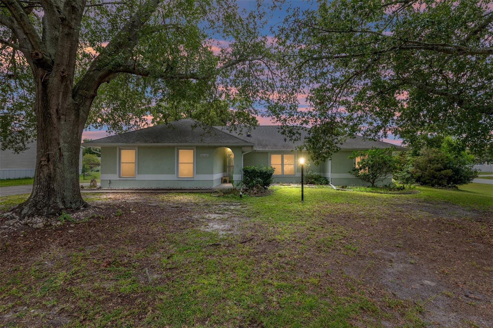Welcome to this charming three-bedroom, two-bathroom home situated on a spacious quarter acre corner lot. The open layout features cathedral ceilings, an inviting screened lanai, and mature landscaping that provides a touch of privacy and curb appeal. Additional highlights include an inside laundry room, two-car garage, and the freedom of no HOA. Perfectly located just minutes from dining, shopping, parks, and schools this home offers both comfort and convenience.