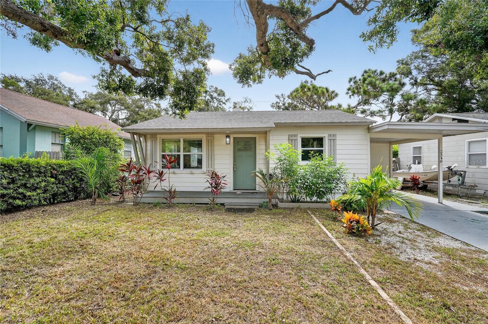 Welcome to this beautifully updated three-bedroom, two-bathroom home in St. Pete, offering modern upgrades and a spacious layout perfect for Florida living. From the charming front porch and carport parking to the huge fenced-in backyard, this home has it all. Inside, you’ll find fresh paint, wood-look laminate flooring, and a bright living room and kitchen combo with ceiling fans for comfort. The kitchen is updated, featuring granite countertops, stainless steel appliances, a stylish backsplash, and a new sink & faucet. A spacious laundry room with cabinets and extra storage makes everyday tasks a breeze. The split floor plan provides privacy, with updated bathrooms that include new vanities, mirrors, and fixtures. The primary suite offers its own attached bathroom with a beautifully tiled walk-in shower. Step outside to enjoy the expansive fenced backyard with a wooden deck, ideal for grilling, gardening, lounging, and outdoor activities. A storage shed provides plenty of space for lawn equipment and tools. Conveniently located near 34th Street with endless dining options, this home is also close to nature parks, Twin Brooks Golf Course, the Gulf beaches, and I-275 for easy travel. Downtown St. Pete is just 8 minutes away via I-275, where you’ll find even more dining options, boutique shopping, museums, events, and activities. This move-in-ready St. Pete home blends comfort, updates, and location, perfect for enjoying the Florida lifestyle. Schedule your private showing today!
