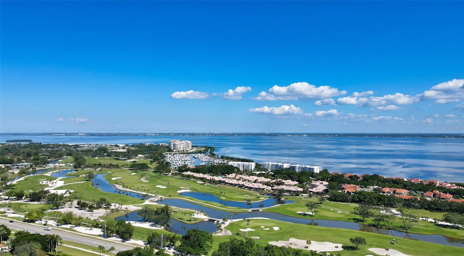 Wonderful "Manhattan Style" beachfront Condo with sweeping views of Sarasota Bay and views of the Gulf now available at the popular Islander Club on LBK. This gorgeous beachfront renovation was completed 4 years ago and truly shows all the craftmanship that went into the process under the owner's direction. Open kitchen beings the morning light into the room for enjoying your coffee or tea as you gaze across the sparking blue waters of the bay. Large 38ft balcony also has views of bay and a bit of the Gulf of Mexico. The Primary suite is a comfortable 13X20 which accesses the balcony and has a large walk-in closet. It is light and bright and a restful haven away from the main living area. The Islander club has recently renovated their clubhouse. The gym overlooks the gulf and the pool. There is a conference room,  library, and an Olympic size heated pool, not to mention their Har-Tru tennis courts. The Location is very convenient. The shops of Bay Isles with the Publix and CVS are just a couple of minutes away. It's only 10 minutes to World renown St Armand Circle. Make this your permanent home or your week-end getaway. Secured Building . At  The Islander Club "Everyday is a Holiday and Life is an endless vacation.