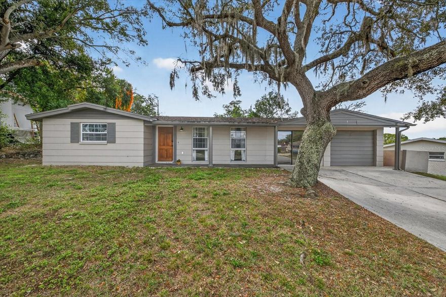 One or more photo(s) has been virtually staged. Must see! Welcome to 5404 Front Dr in Holiday, FL, where space, style, and location come together on an oversized .21-acre lot with room to roam, expand, and even potentially add a pool. Best of all, there’s NO HOA or deed restrictions, giving you the freedom and flexibility today’s buyers dream of! Plus, this move-in-ready home is located in desirable Flood Zone X for added peace of mind.

Inside, you’ll find approximately 1,240 sq ft with an additional 200 sq ft (approximate) under air, featuring 3 bedrooms plus a bonus 4th bedroom, 2 full bathrooms, and a garage conversion that offers extra living space—perfect for a primary suite, home office, or private guest retreat.

The updated kitchen is sure to stop your scroll, showcasing refreshed cabinetry with new pulls, a stylish backsplash, sleek butcher-block countertops, a modern sink, stainless steel appliances, and durable LVP flooring—ideal for both everyday living and entertaining. The main bathroom is tastefully updated with beautiful new tile, classic subway tile, and updated fixtures, with no detail overlooked.

The spacious enclosed Florida room (approximately 10x20) adds even more versatility and can easily serve as a family room, media room, playroom, or work-from-home space. Per records, major updates include a roof (2016), AC (2019), and several windows have been replaced!

All of this is in a prime location with quick access to US Highway 19 for easy commuting, just minutes from the sugary sand Gulf beaches and the Jolley Trolley, and a short drive to the charm of the historic Tarpon Springs Sponge Docks. Opportunities like this don’t last—act fast and make this incredible home yours today!