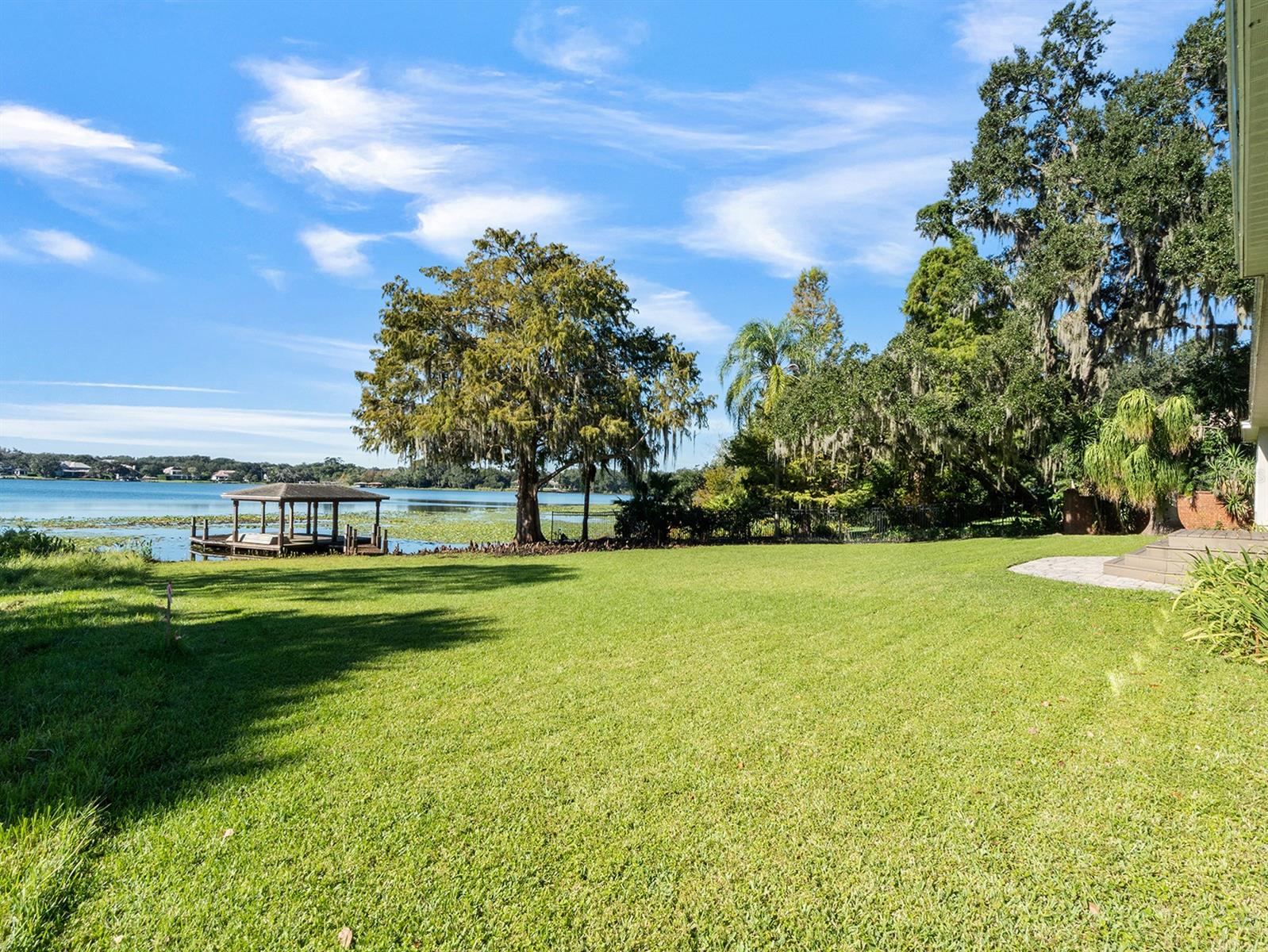 An exceptional opportunity to design and build your dream lakefront home in Winter Park. Positioned on the shores of Lake Berry, one of the area’s private and pristine ski lakes with no public boat ramp, this property offers a rare combination of privacy, location and potential. Set on over a half-acre of lakefront land, the property features a four-bedroom, two-and-a-half-bath, single-story residence with a covered boat dock, ideal for enjoying lake life immediately or while planning a future custom build. The northeast-facing front provides the ideal orientation to capture breathtaking sunsets across the water each evening. Whether you choose to renovate the home or build a new architectural masterpiece, this offering presents the ultimate canvas for creating a generational lakefront retreat. Within minutes of downtown Winter Park, Park Avenue and A-rated public schools, this property combines the best of convenience, serenity and luxury lakefront living. A special opportunity to bring your vision to life on one of Winter Park’s desired private lakes.
