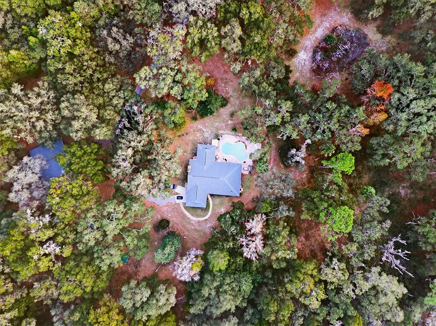 15.17 ACRES 11 MILES FROM THE WORLD EQUESTRIAN CENTER AND 8.5 MILES TO THE CRYSTAL CLEAR WATER OF RAINBOW SPRINGS. 1 OF FLORIDA'S BEAUTIFUL NATURE SPOTS WITH AN ABUNDANCE OF WILDLIFE AND BIRD SANCTUARY! THIS PROPERTY HAS MORE TO CONSIDER THEN JUST FOR THE EQUESTRIAN AND AVID NATURE ENTHUSIAST!

Think about it........15.17 acres, No Hoa, zoned A-1, not in a flood zone, 2 RV hookups in place with room for a lot more, gated, easy access to main highway, loads of mature live oaks, and a barn ready for any of your imagination to put your passive income dreams into place here.  Think rv opportunity, air bnb or vrbo, boarding of horses so close to wec with rv hook ups ......The growth in this area is one to be considered for long term success!

Long winding and paved road leads to ..Home(caretakers home) and barn/workshop/amenities center has 2025 new 30 year architectural roof, newer a/c system with UV light, water softener,and electric breaker panel. Exterior paint 2025. 

This inviting open floor plan features modern finishes and plenty of room to live or provide a great space for your passive income needs. The home has 2 living areas one with stone wood burning fireplace overlooking pool. 3 dining areas with inviting kitchen perfect for entertaining or events on site such as cooking classes or wine tasting!The kitchen has quarts countertop , massive island, stainless steel appliances, custom backsplash and a walk in pantry. This area overlooks the pool oasis as well with 2 level, step up down  pool deck with plenty of room set up perfect for plenty of sun loungers and summer kitchen area. All bedrooms are spacious and have modern finishes in the bathrooms. Enclosed lanai is an extension on living area and is a peaceful area to take in the true beauty of this 15 acre property. 

There is more than meets the eye on this one. Think bigger picture, endless opportunities await you in this unique property.