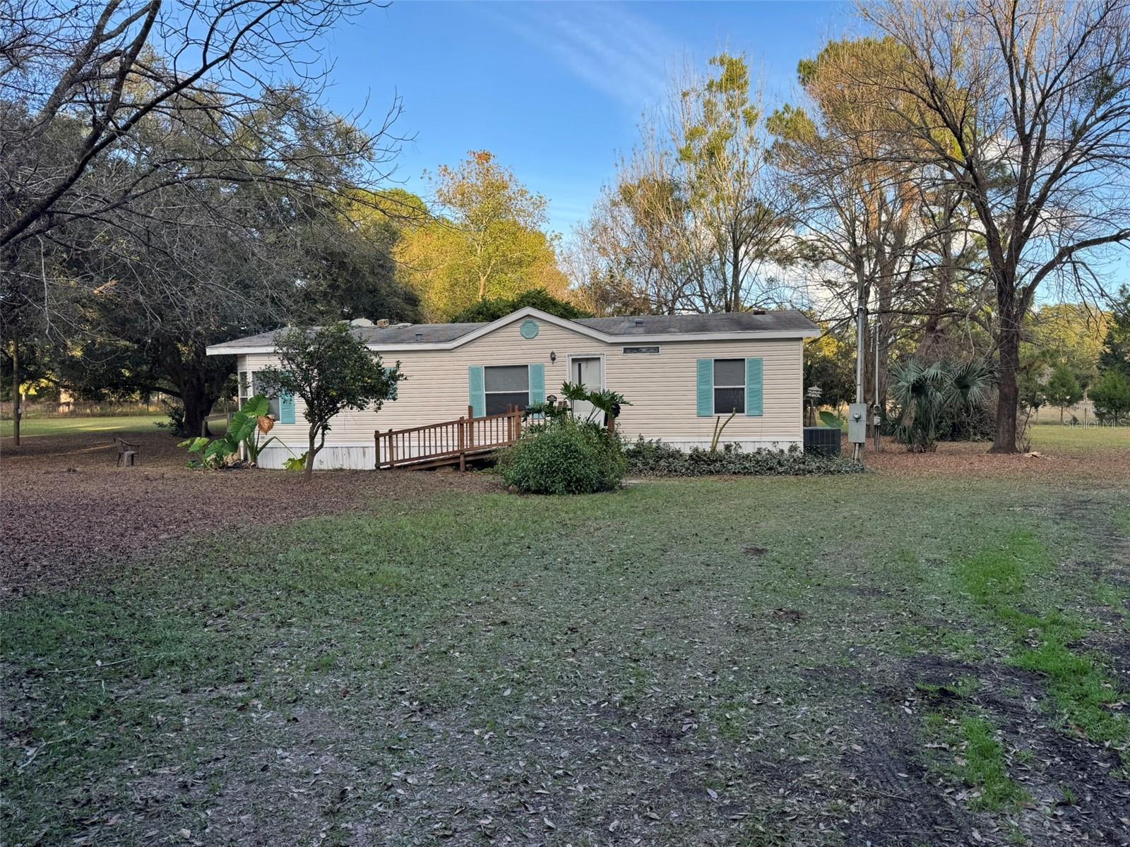 Handyman/Investor opportunity! This 3/2 manufactured home rests on 2 parcels totaling 6.34 acres of pristine agricultural land. The property backs up to a 26-acre farm contributing to its rural lifestyle and privacy. Along with the home, you will also find a storage shed, a large chicken coop with power, and a second power pole with a 40amp RV hookup. This home features a galley kitchen an eat-in breakfast area and a separate laundry room. Directly off of the kitchen, you will find a sizable dining space open to the living room. Directly off the living room the master with a walk-in closet, and En-suite featuring a walk-in shower, soaker tub, and dual sink vanity. On the opposite end of the home are two additional bedrooms, and a bathroom. The house needs repairs throughout but a few upgrades such as a new a/c in 2023 and a new water heater in 2024 have already been completed. This can be a great opportunity for a DIY project, handyman, or investor!