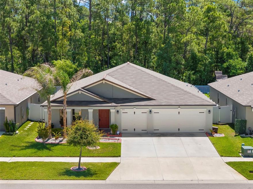 One or more photo(s) has been virtually staged. Built in 2021, this well maintained Lincoln floor plan has just under 2,600 sq.ft. with  4-bedrooms, 2-bathrooms, an office and a 3-car garage on a Conservation Lot! This location is not in a Flood Zone and has a Low HOA.  This elevation includes an extended front porch, creating the perfect sitting area to enjoy the lush landscaping, while the flower beds are enhanced with concrete landscape edging for added curb appeal.  Inside, there is a foyer that creates a drop zone and space for separation from daily living along with a flex space that is currently being used an a home office.  Ceramic tile throughout the main living spaces and bathrooms provides a clean, consistent look while being durable and easy to maintain. The open-concept layout creates a spacious and welcoming main living area, seamlessly connecting the kitchen, dining, and living spaces for easy entertaining and comfortable living. High ceilings add to the bright and airy feel, while the oversized kitchen island serves as the centerpiece overlooking the entire great room. The kitchen features granite countertops, a tile kickplate, and an oversized walk-in pantry, offering plenty of storage and workspace. The oversized screened lanai extends your living space outdoors and is designed for both relaxing and gatherings, with plenty of room for multiple seating areas and outdoor dining. The backyard offers an impressive amount of space with a fully fenced layout and gated access, providing plenty of room for outdoor activities, pets, or future additions. Backing to a peaceful conservation area with no rear neighbors, the yard combines privacy with a serene natural setting.  Back inside, the spacious primary bedroom offers plenty of room for oversized furniture and features large windows and space to add a lounging area.  The en-suite bathroom has dual sinks, walk-in shower and a private water closet. The walk-in closet provides an abundance of storage space with room for clothing, accessories, shelving, and additional organization options. The split floor plan offers added privacy, with the three generously sized secondary bedrooms located on the opposite side of the home. They have immediate access to the second full bathroom, which features a tub and shower combination with tiled shower walls and coordinating finishes that match the primary bathroom.  The laundry room is large and has space for additional storage.  The spacious 3-car garage provides ample room for vehicles, storage, tools, and recreational equipment, offering both functionality and flexibility.  Also, the remainder of the builder warranty will transfer! South Fork is a pet-friendly community with amenities that include a zero-entry community pool, dog park, basketball court, playgrounds, walking trails connecting neighborhoods, outdoor fitness stations, and more. Conveniently located near shopping and restaurants, and just minutes from I-75, offering easy access to Tampa, Brandon, and surrounding areas.